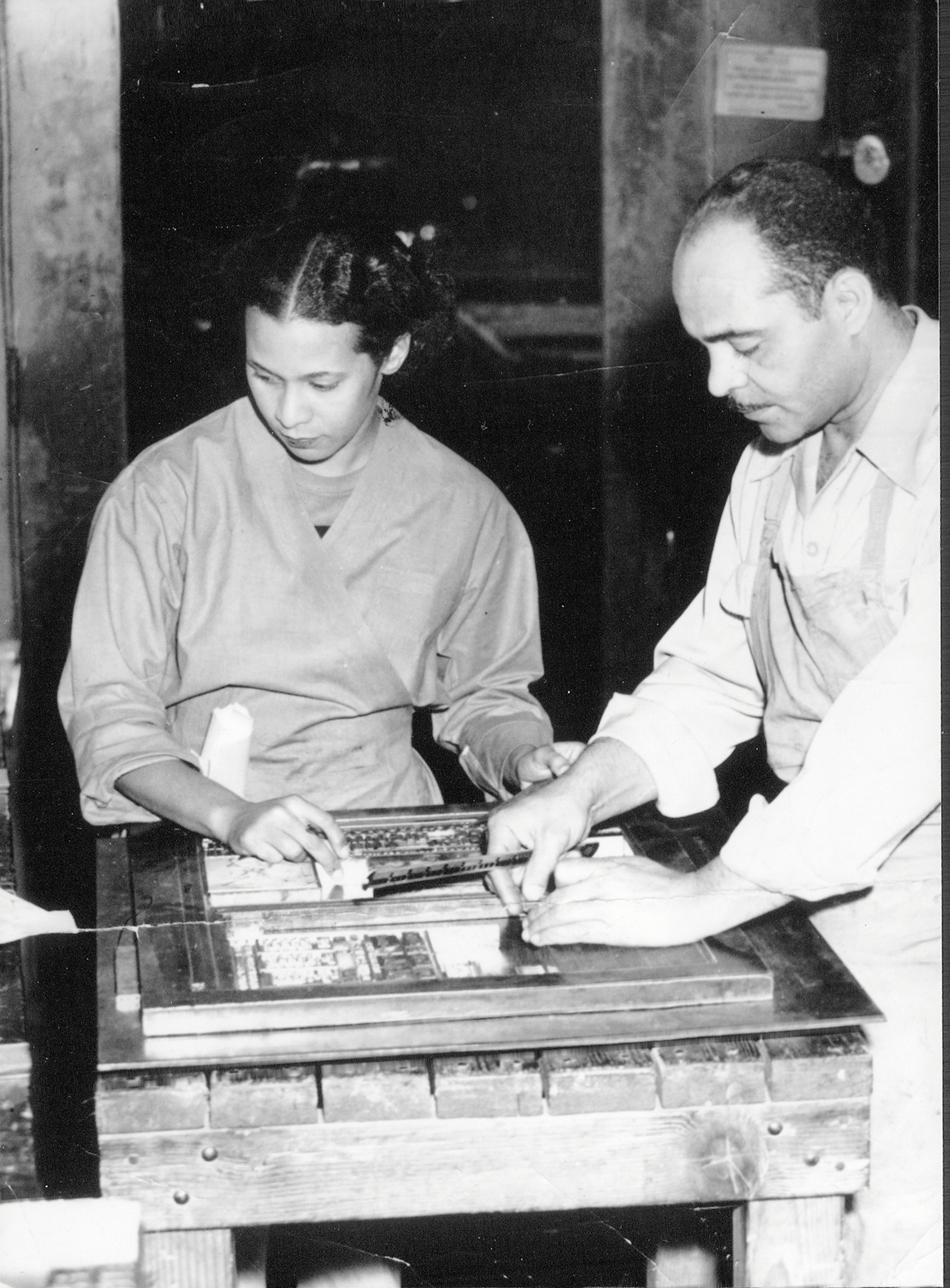 A circa 1950s photo of publishers of the Los Angeles <i>Tribune</i> Lucius and Almena Lomax, parents of Michael Lomax, setting the typeface to print the newspaper.