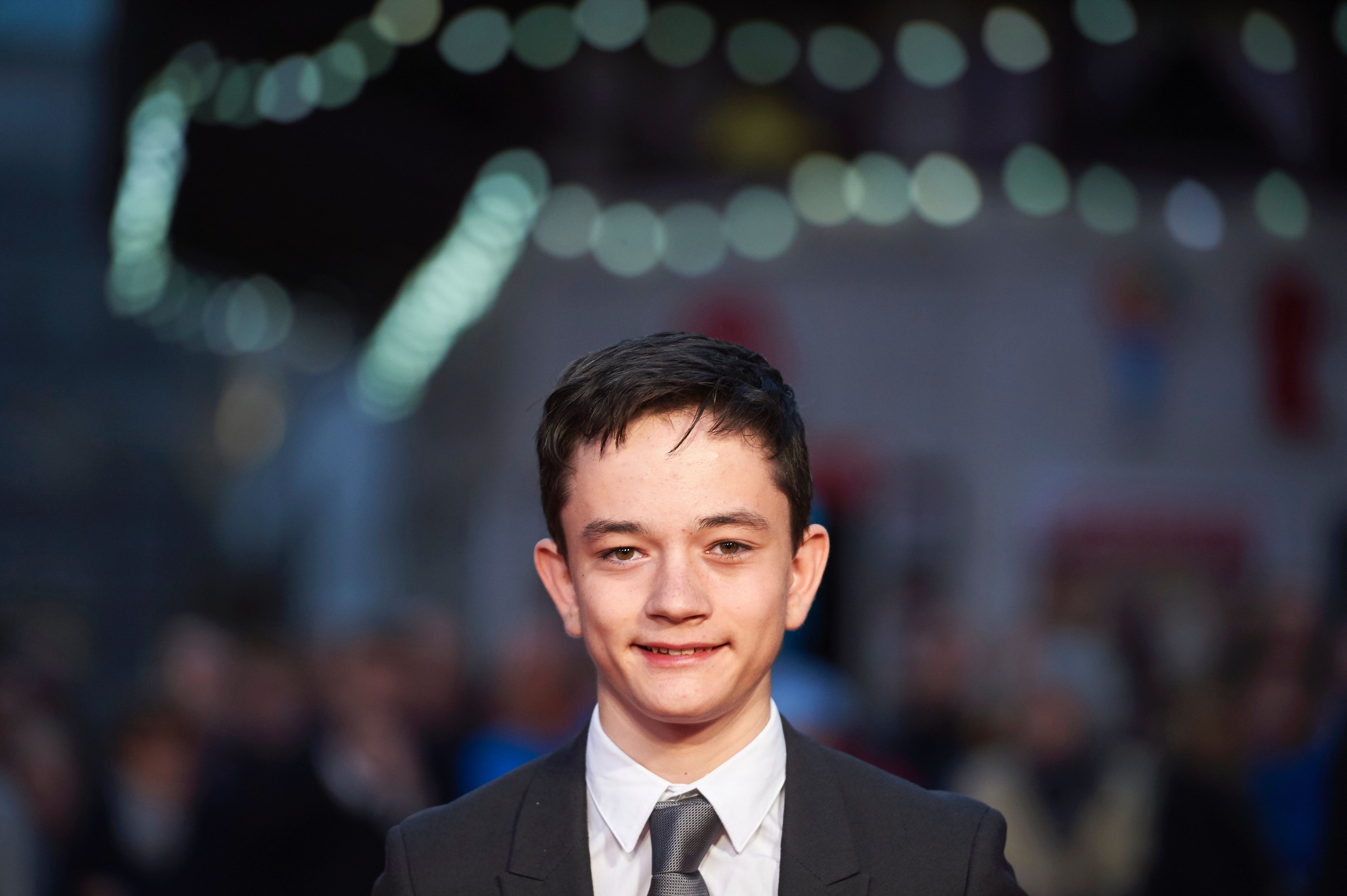 British actor Lewis MacDougall poses on the red carpet as he arrives to attend a gala screening of the film "A Monster Calls" during the BFI London Film Festival in London on October 6, 2016.