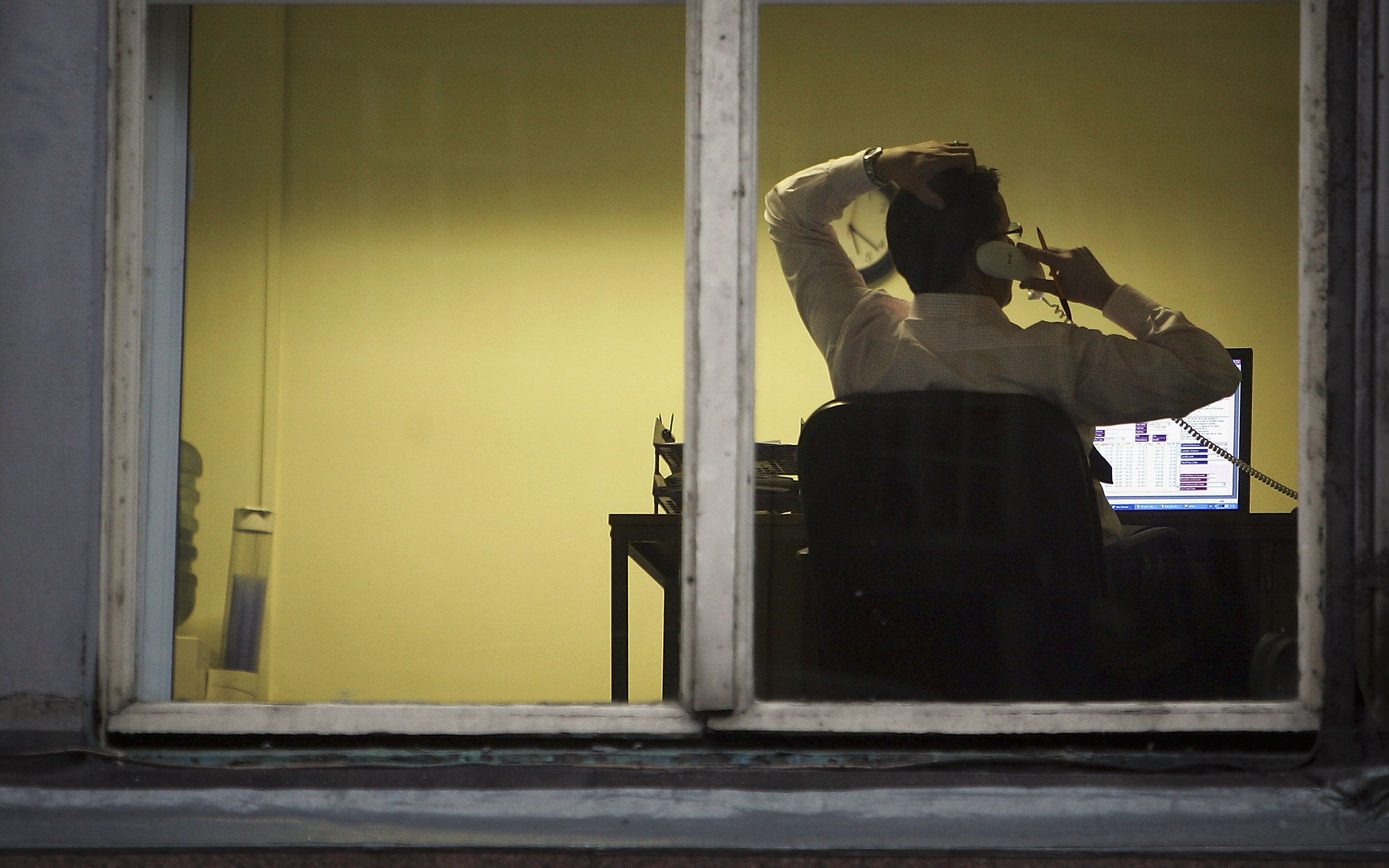 A city office employee works into the night as darkness closes in on October 10, 2005 in Glasgow, Scotland.