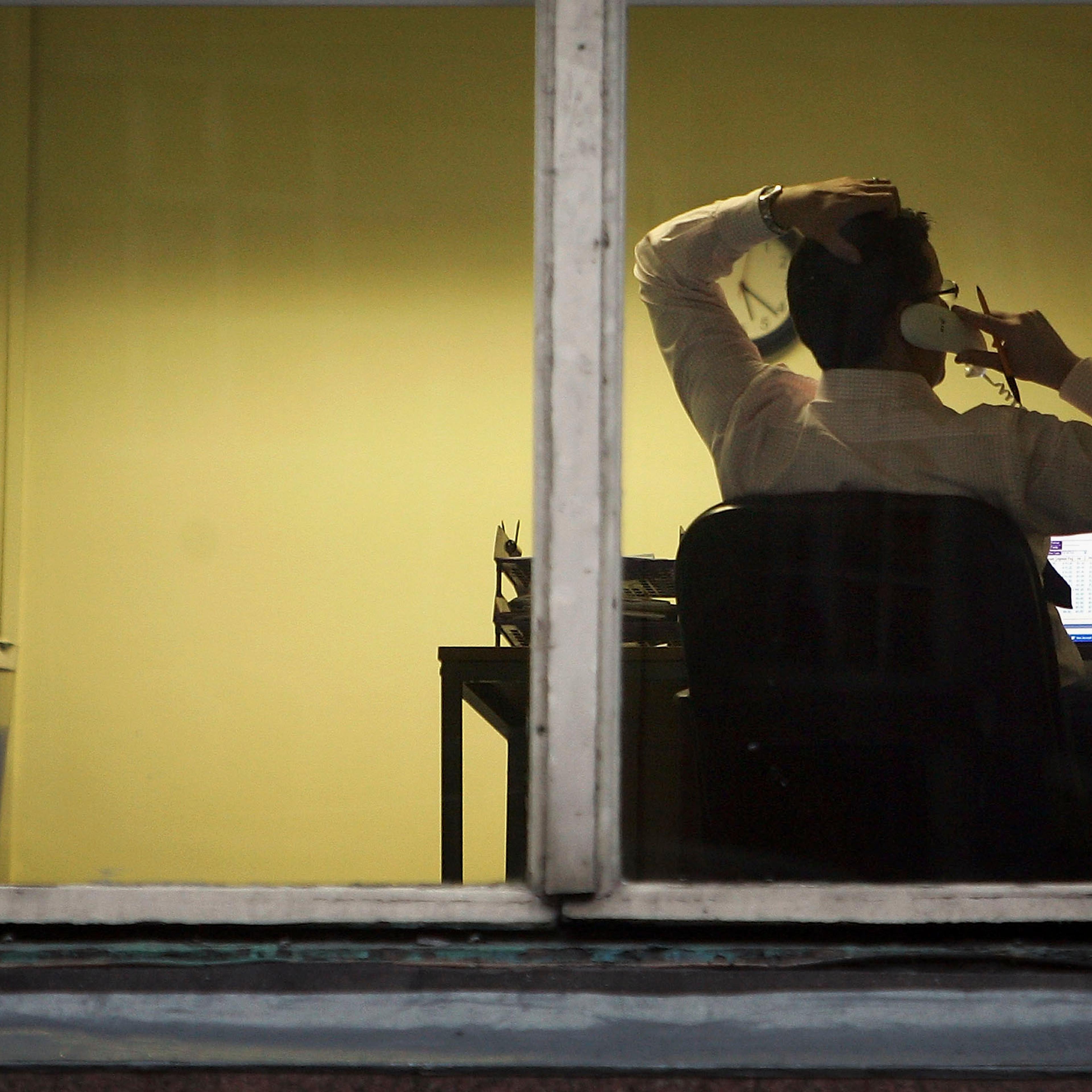 A city office employee works into the night as darkness closes in on October 10, 2005 in Glasgow, Scotland.