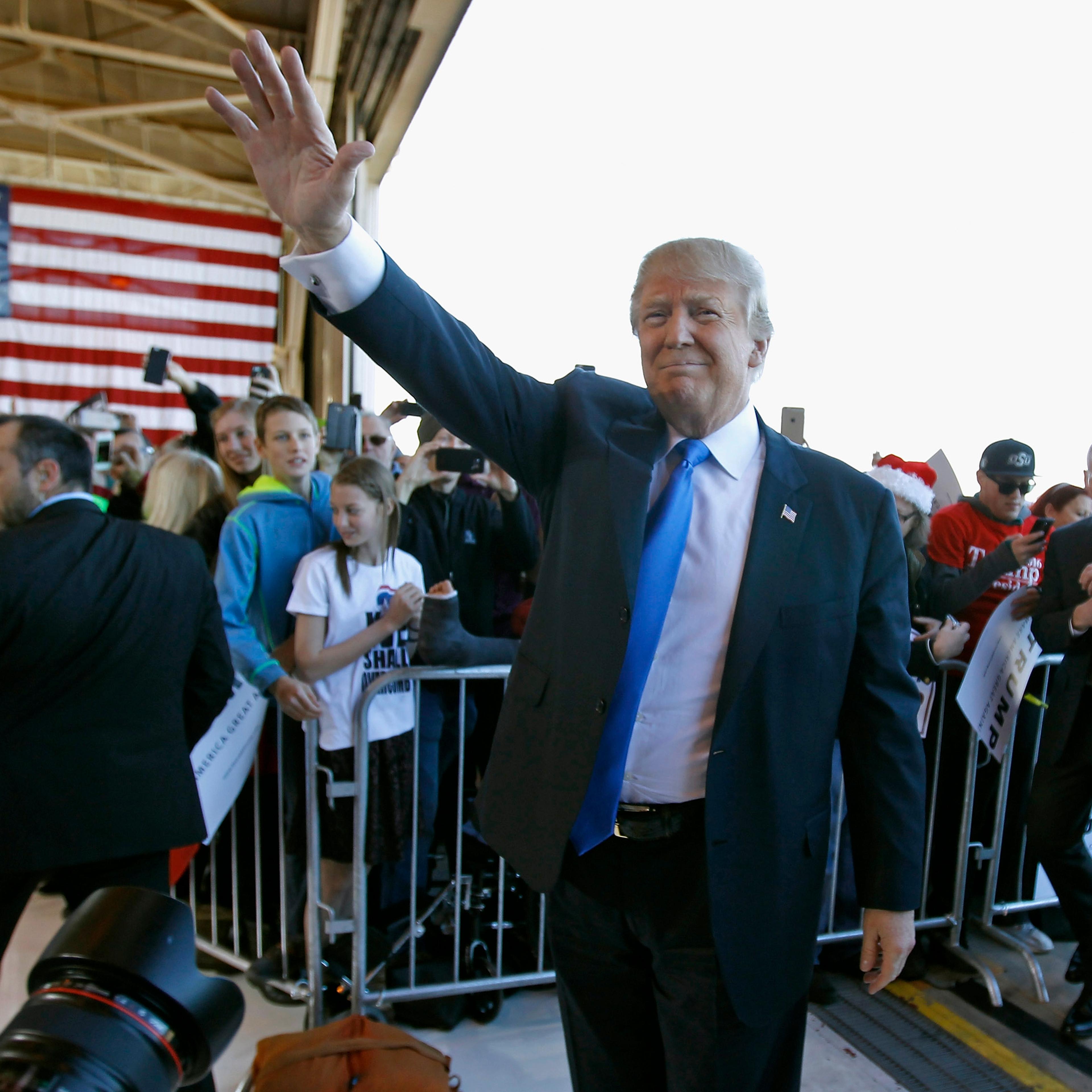Donald Trump waves to the crowd as he arrives at a campaign event at the International Air Response facility on Dec. 16 in Mesa, Arizona.