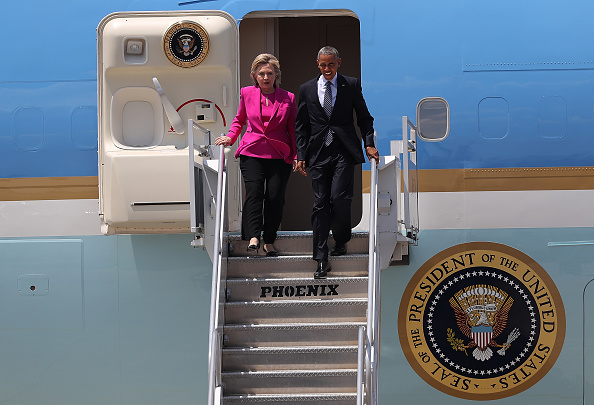 Democratic presidential candidate former Secretary of State Hillary Clinton walks off of Air Force One with U.S. president Barack Obama on July 5, 2016 in Charlotte, North Carolina.