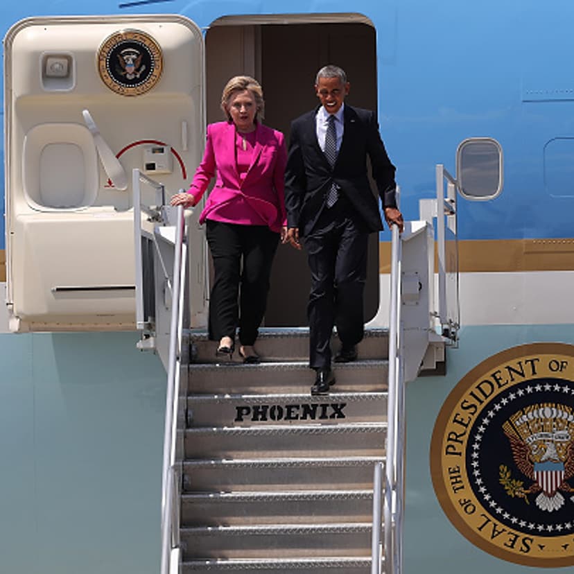 Democratic presidential candidate former Secretary of State Hillary Clinton walks off of Air Force One with U.S. president Barack Obama on July 5, 2016 in Charlotte, North Carolina.