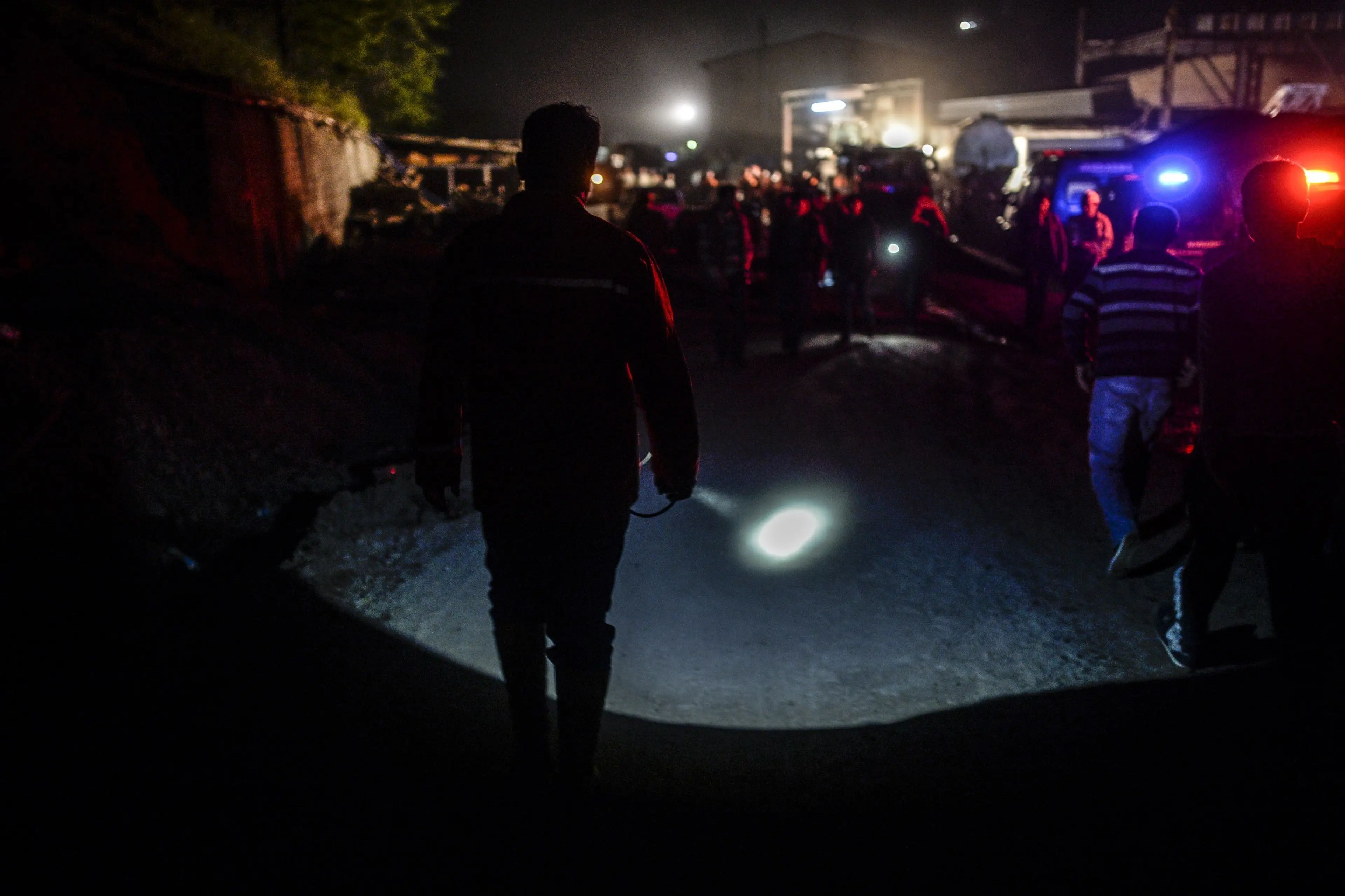 A miner use his lighter as miners wait at the gate of a mine after an explosion in Manisa on May 13, 2014.
