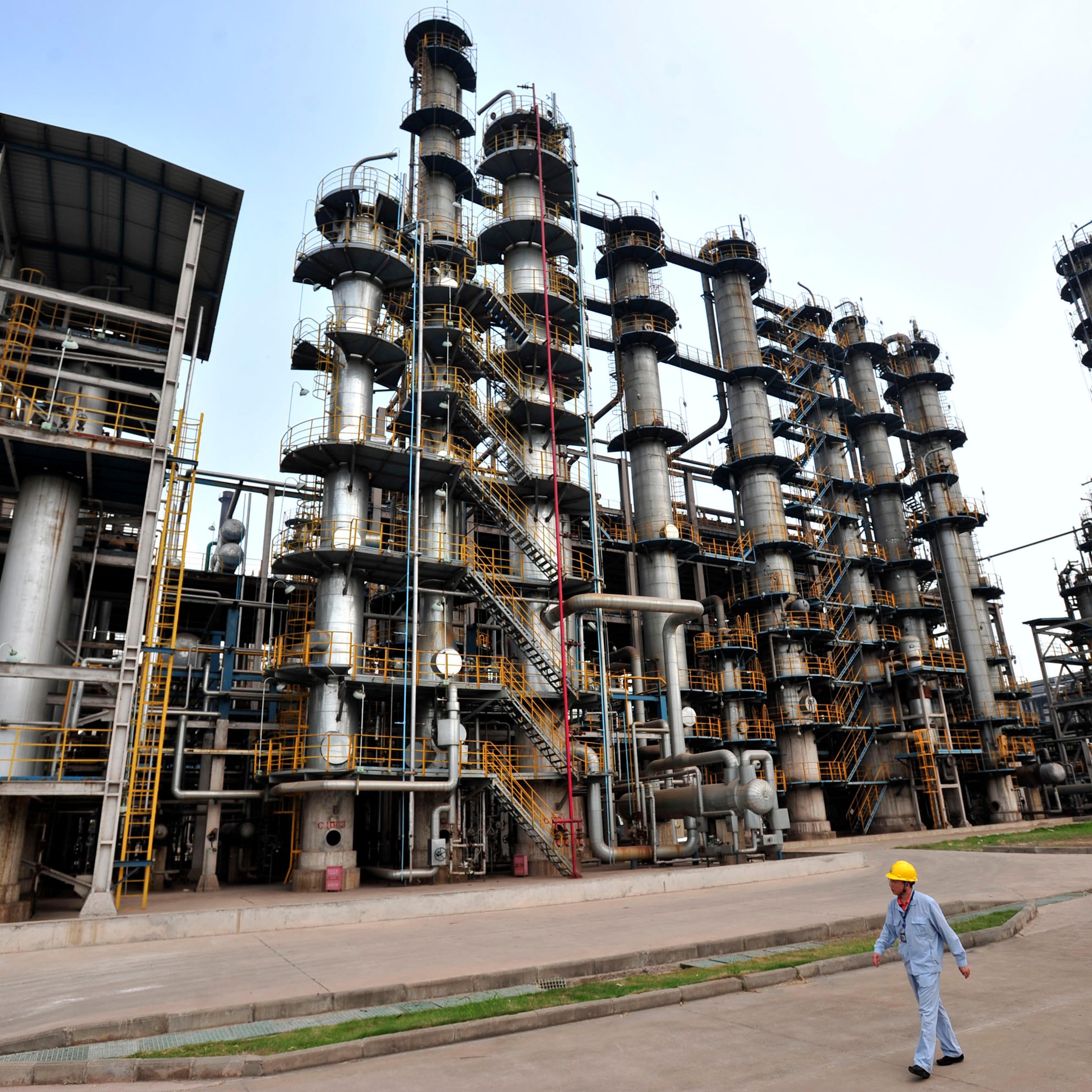 This photo taken on May 10, 2011 shows a worker walking by at an oil refinery of China's Sinopec, in Wuhan, central China's Hubei province.