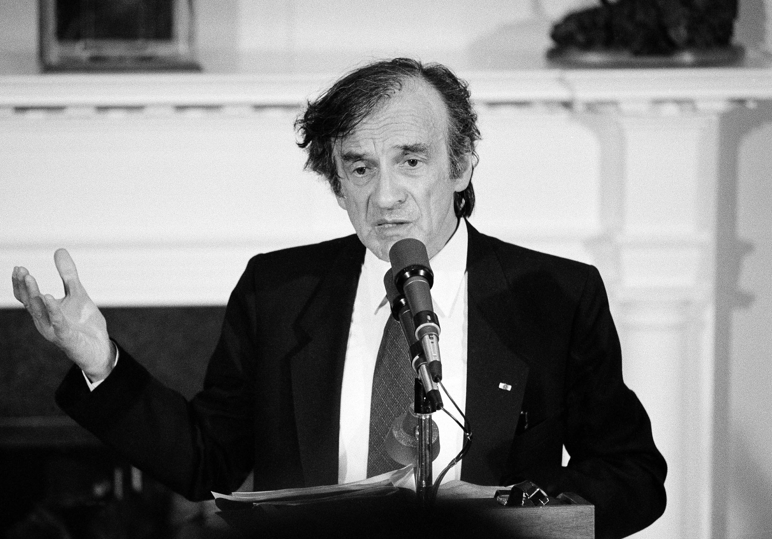 Holocaust survivor Elie Wiesel gestures while talking during a White House ceremony when President Ronald Reagan presented him with the Congressional Gold Medal on April 20, 1985.