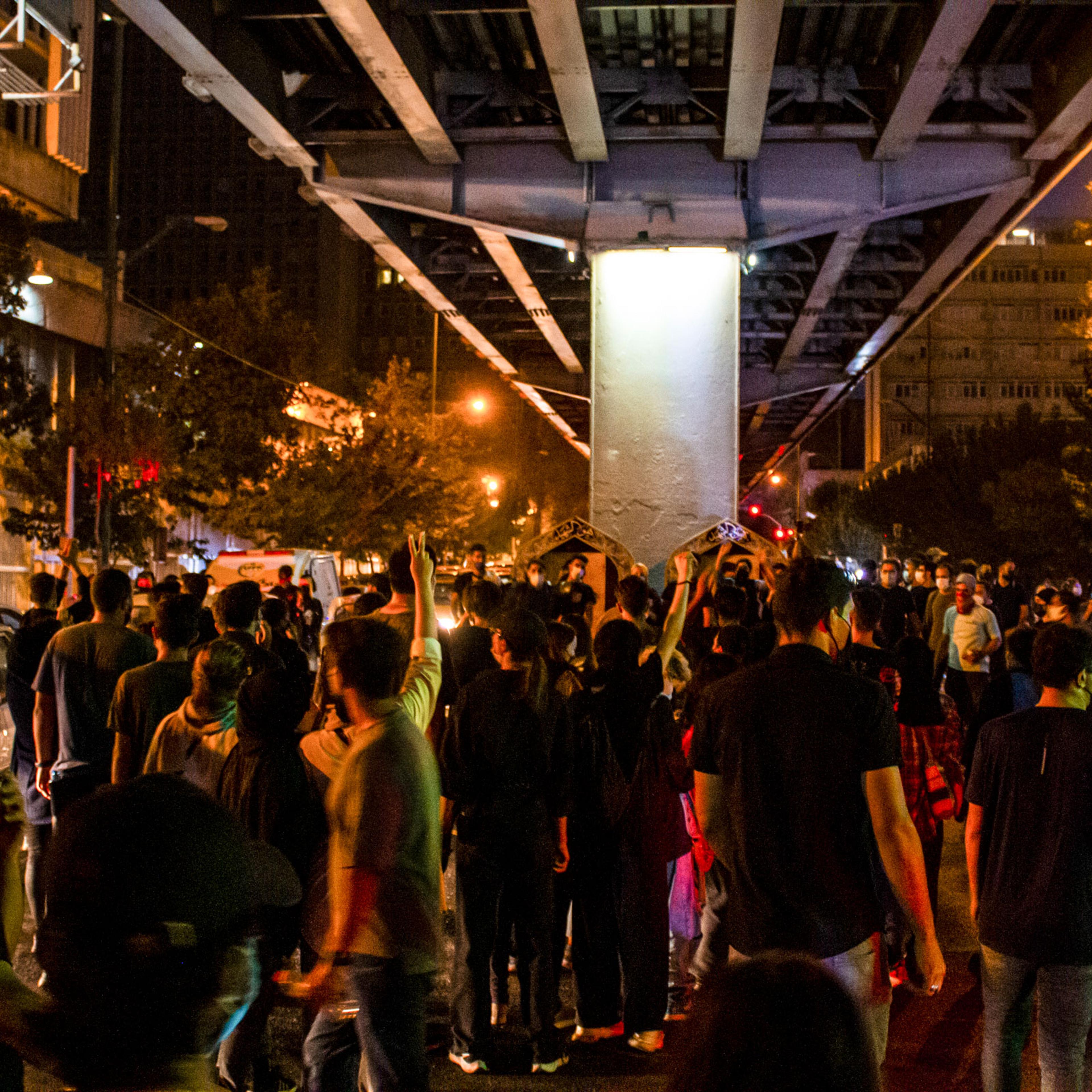 People gather during a protest for Mahsa Amini, who died after being arrested by morality police allegedly not complying with strict dress code in Tehran