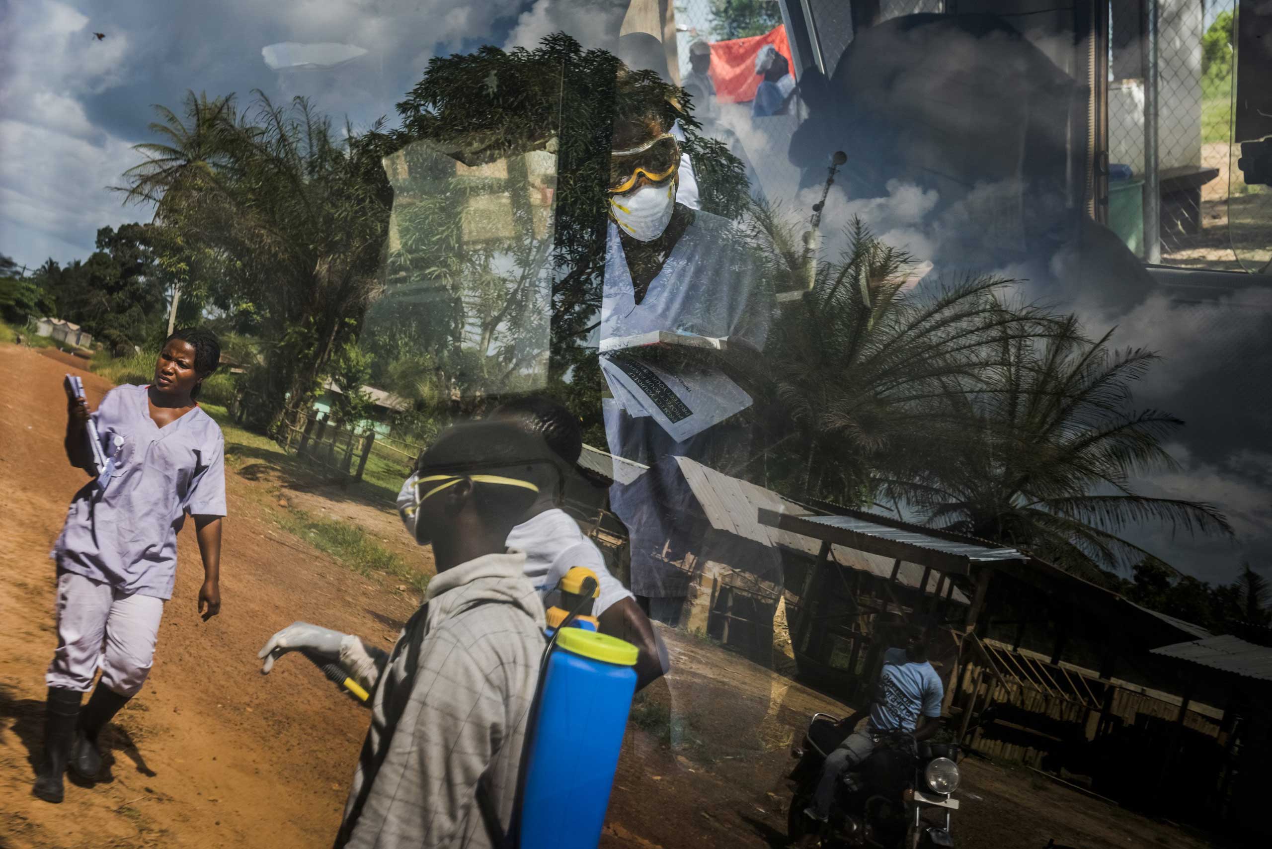 The reflection on an ambulance window of an Ebola outreach team from the Bong County International Medical Corps treatment unit in Kakata, Liberia, Oct. 24, 2014.