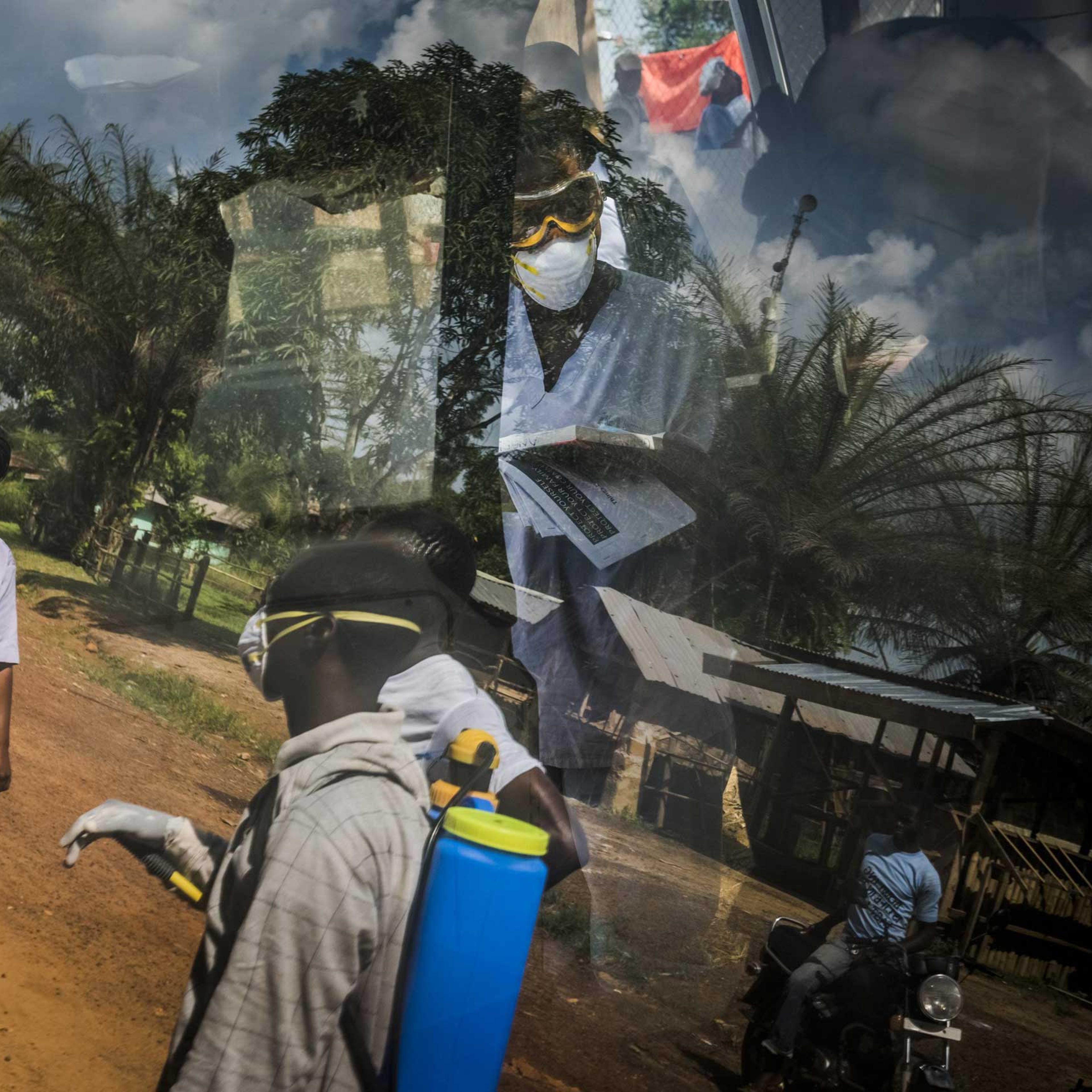The reflection on an ambulance window of an Ebola outreach team from the Bong County International Medical Corps treatment unit in Kakata, Liberia, Oct. 24, 2014.