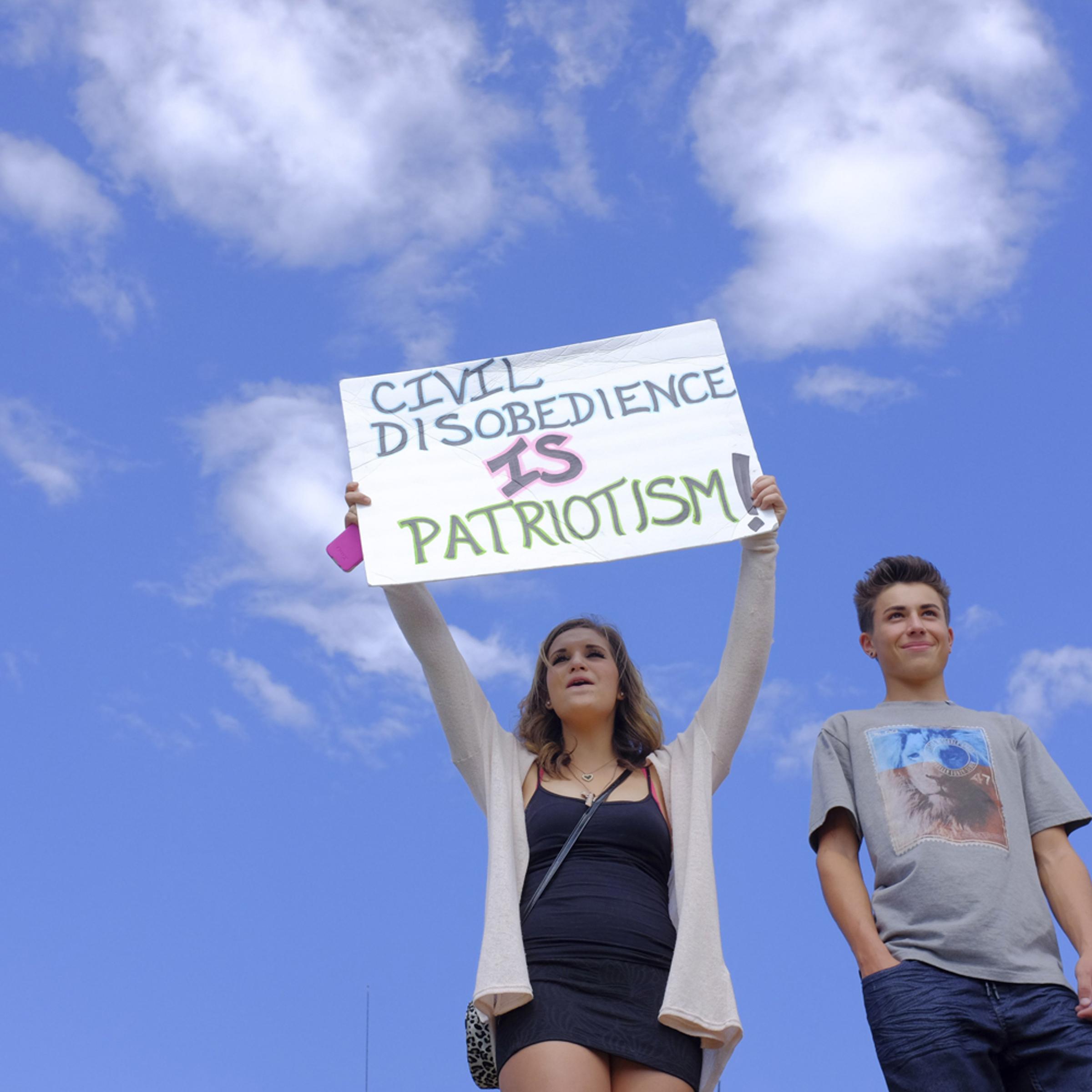 Ella Gonzales and Jordan Miller, high school students, take part in a walkout protest outside Arvada West High School in Arvada, Colo., Sept. 23, 2014.
