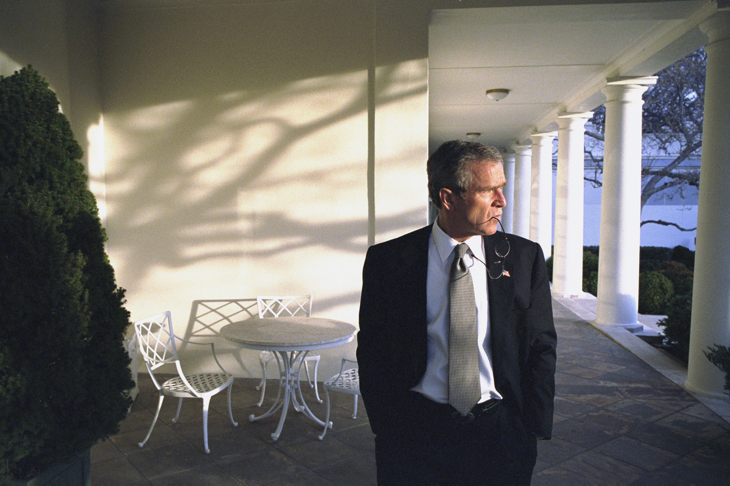 Feb. 15, 2002. President Bush walks across the Colonnade to the Oval Office while taking a break between phone calls to world leaders.<br><br>“It’s ironic that this photo is on the cover of the book. I didn’t remember shooting it until a year later, when my photo editor Mike Davis brought it to me. I said who took that, it’s pretty good. He said, you did.”