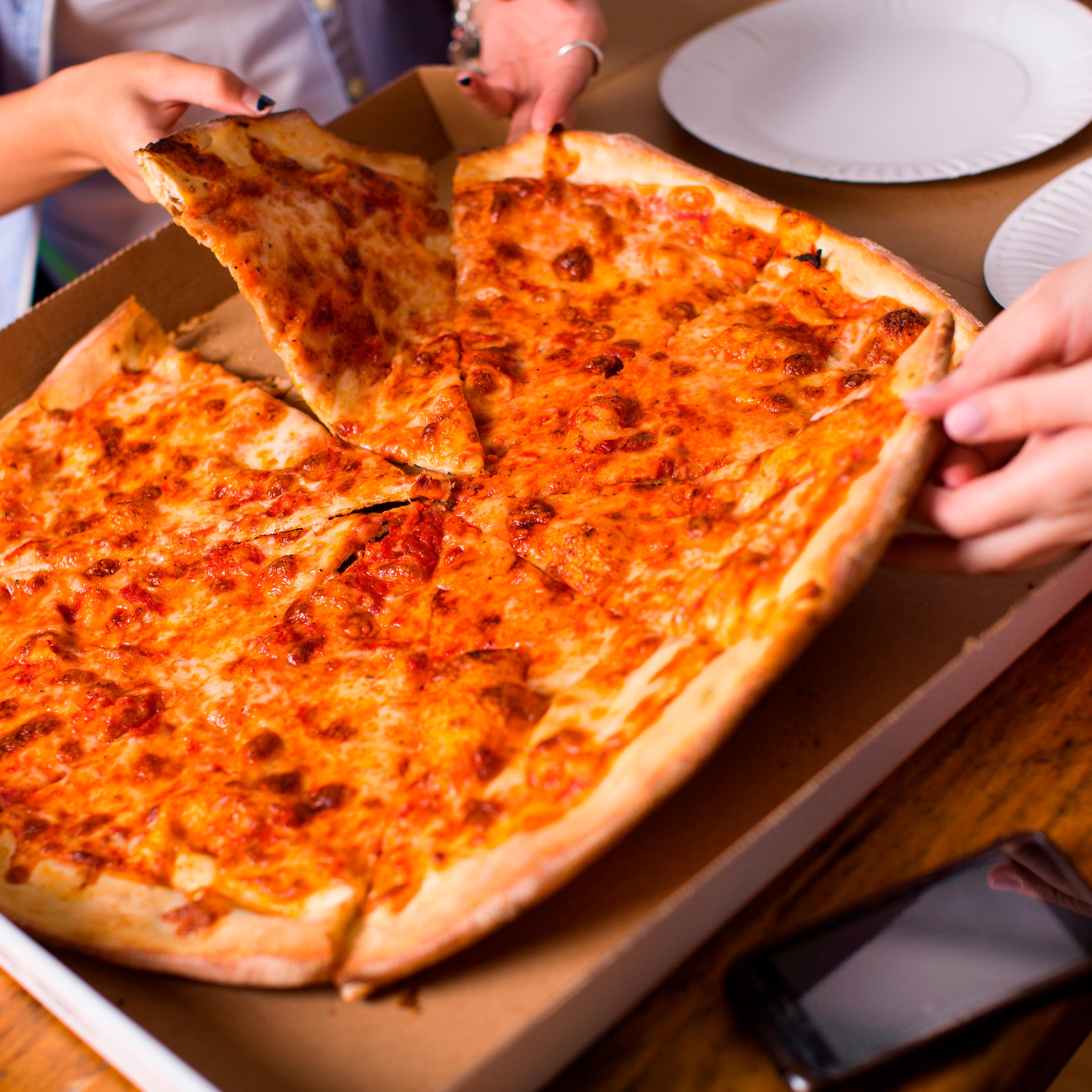 People sharing takeaway pizza