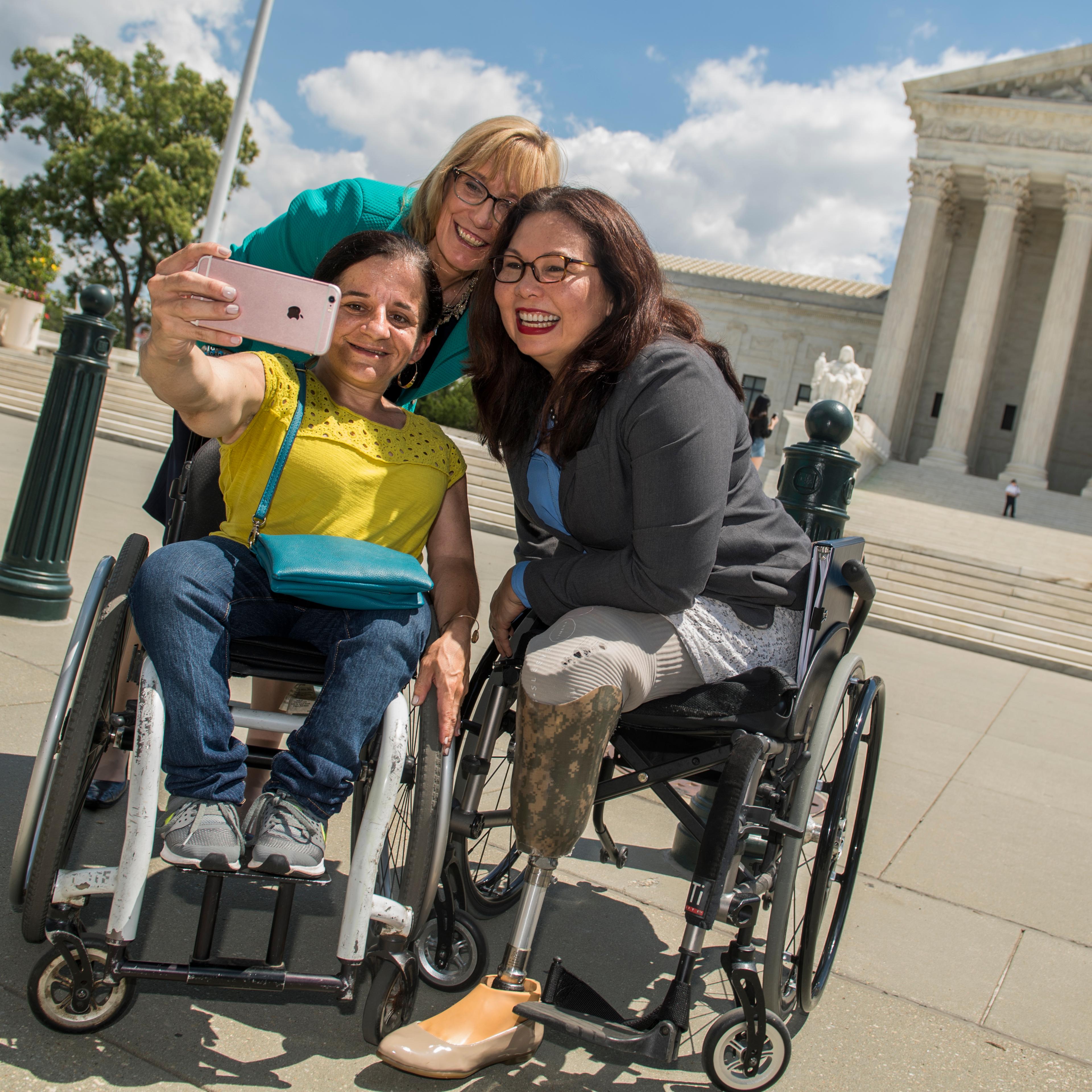 Duckworth takes a selfie with two others