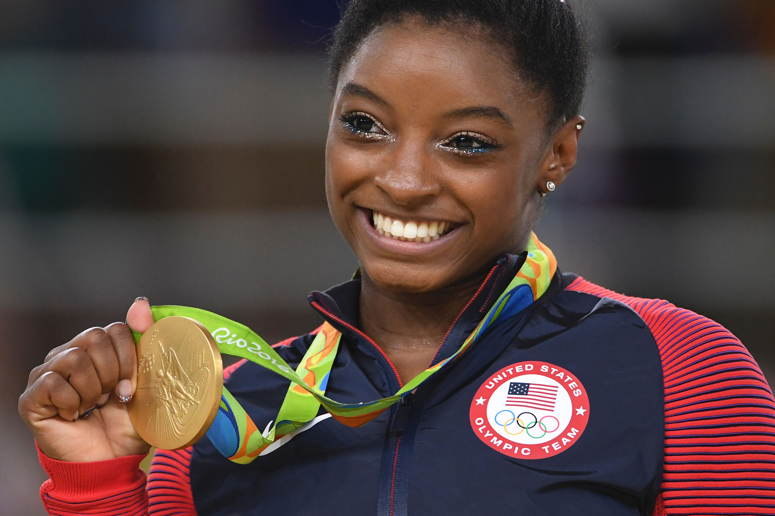Simone Biles celebrates on the podium of the women's floor event final of the Artistic Gymnastics at the Olympic Arena during the Rio 2016 Olympic Games in Brazil on Aug. 16, 2016.