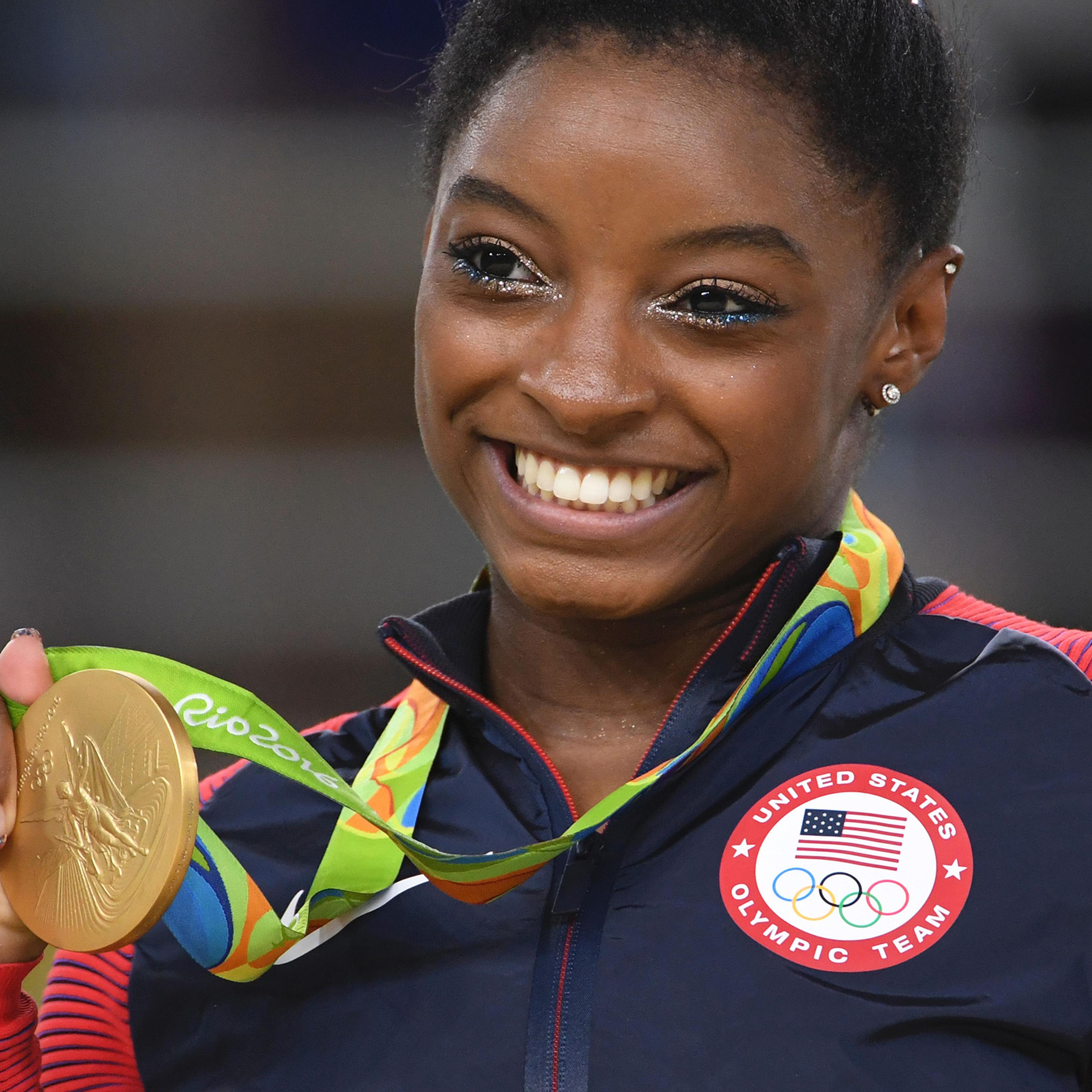 Simone Biles celebrates on the podium of the women's floor event final of the Artistic Gymnastics at the Olympic Arena during the Rio 2016 Olympic Games in Brazil on Aug. 16, 2016.