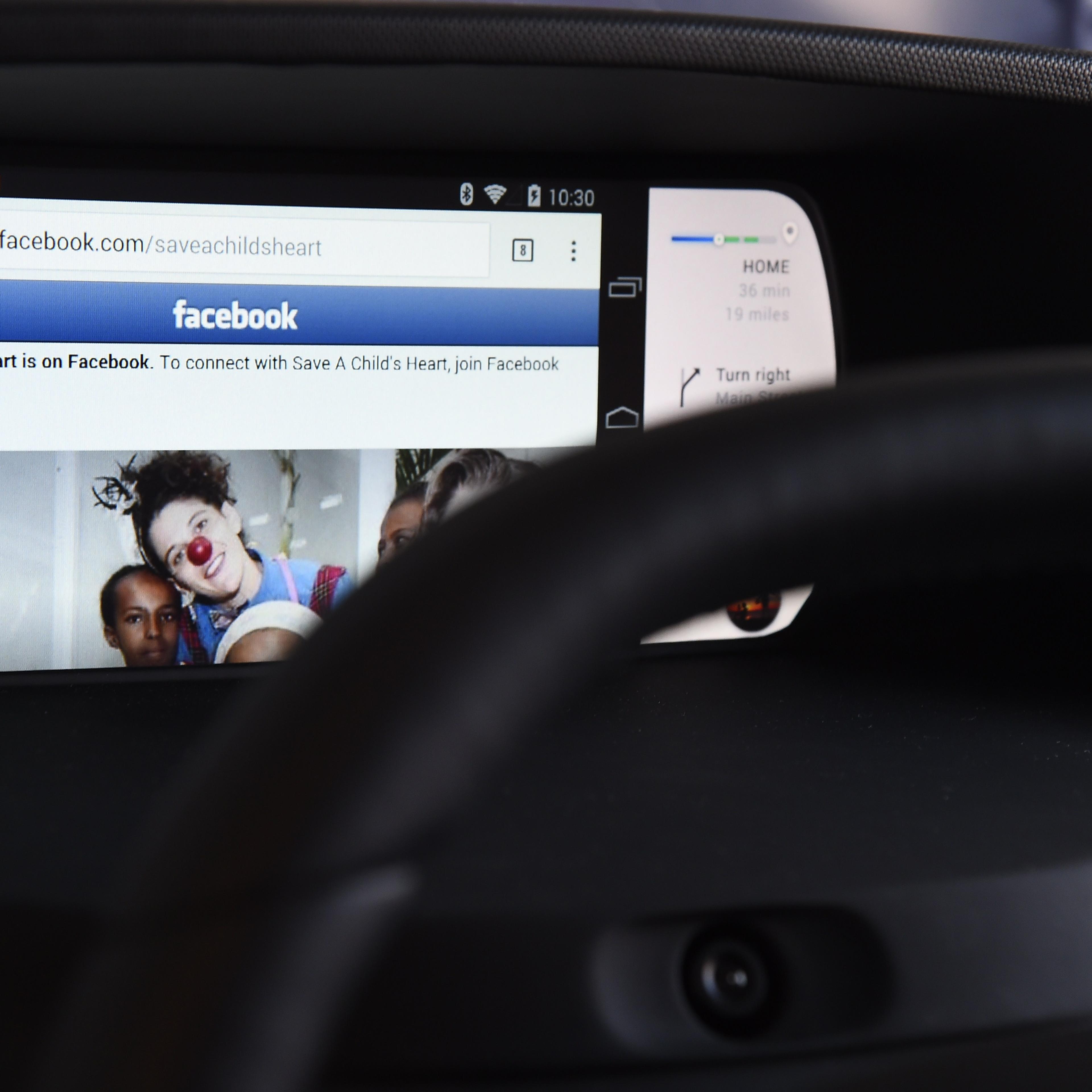 Facebook from a wirelessly connected smartphone is seen on an autonomous dashboard.