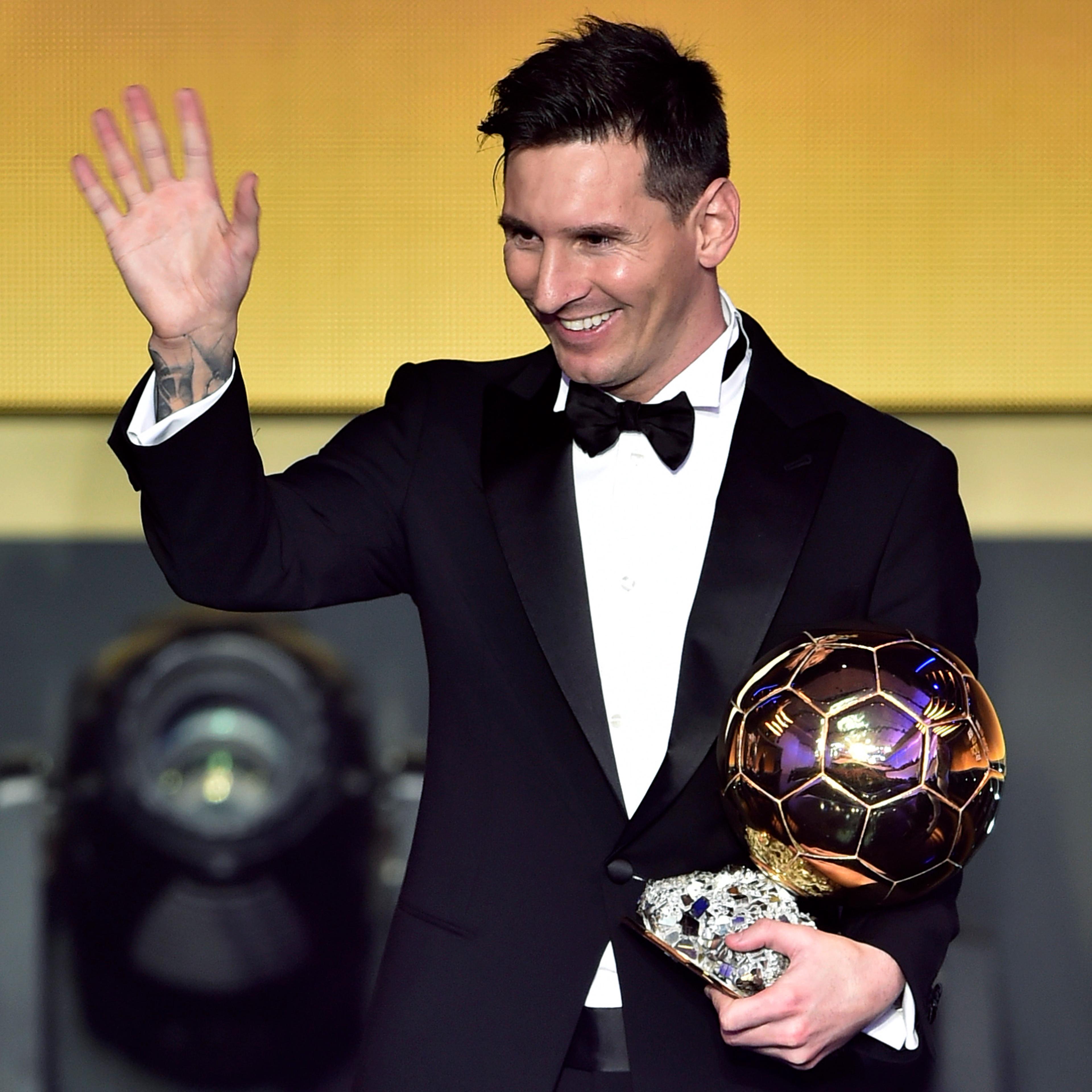 Lionel Messi waves holding his trophy after receiving the 2015 FIFA Ballon dOr award for player of the year during the 2015 FIFA Ballon d'Or award ceremony in Zurich on Jan. 11, 2016.