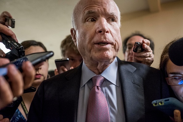 With crowds of journalists asking questions about President Donald Trump and former FBI Director James Comey, Senator John McCain (R-AZ) rushes to the Senate floor for votes on Capitol Hill Wednesday May 17, 2017.