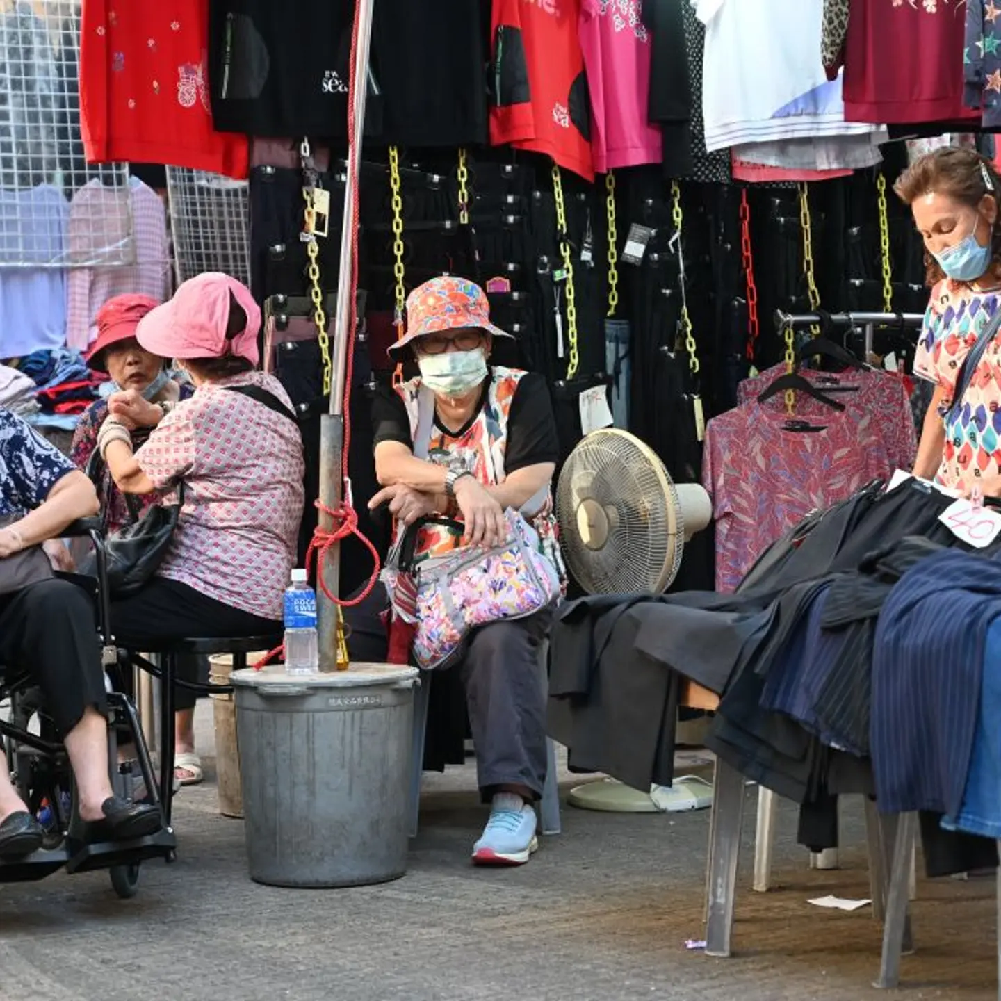 Elderly women hang out in a market in Hong Kong on Sept. 25, 2022.