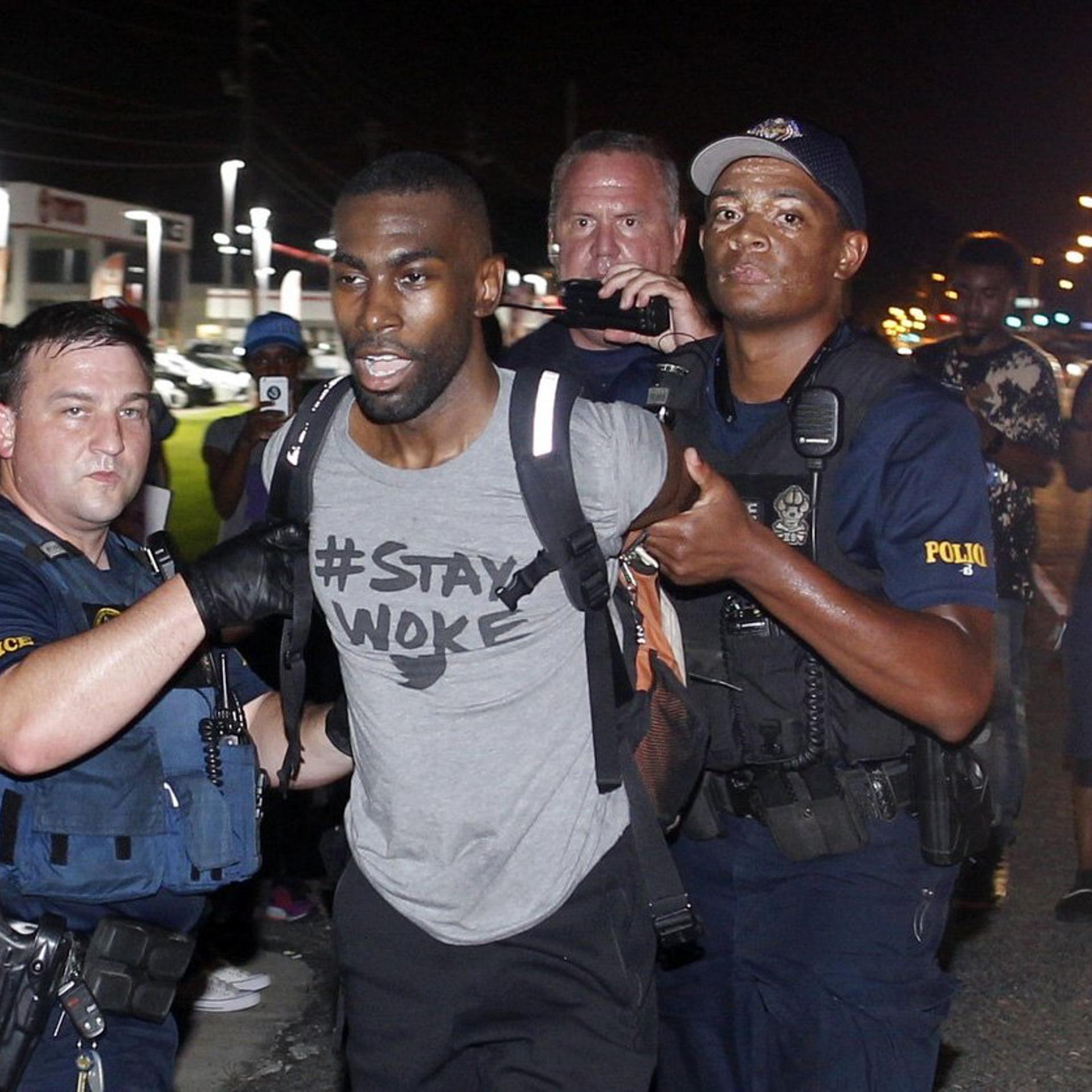 Police arrest activist DeRay McKesson during a protest along Airline Highway, a major road that passes in front of the Baton Rouge Police Department headquarters, July 9, 2016.