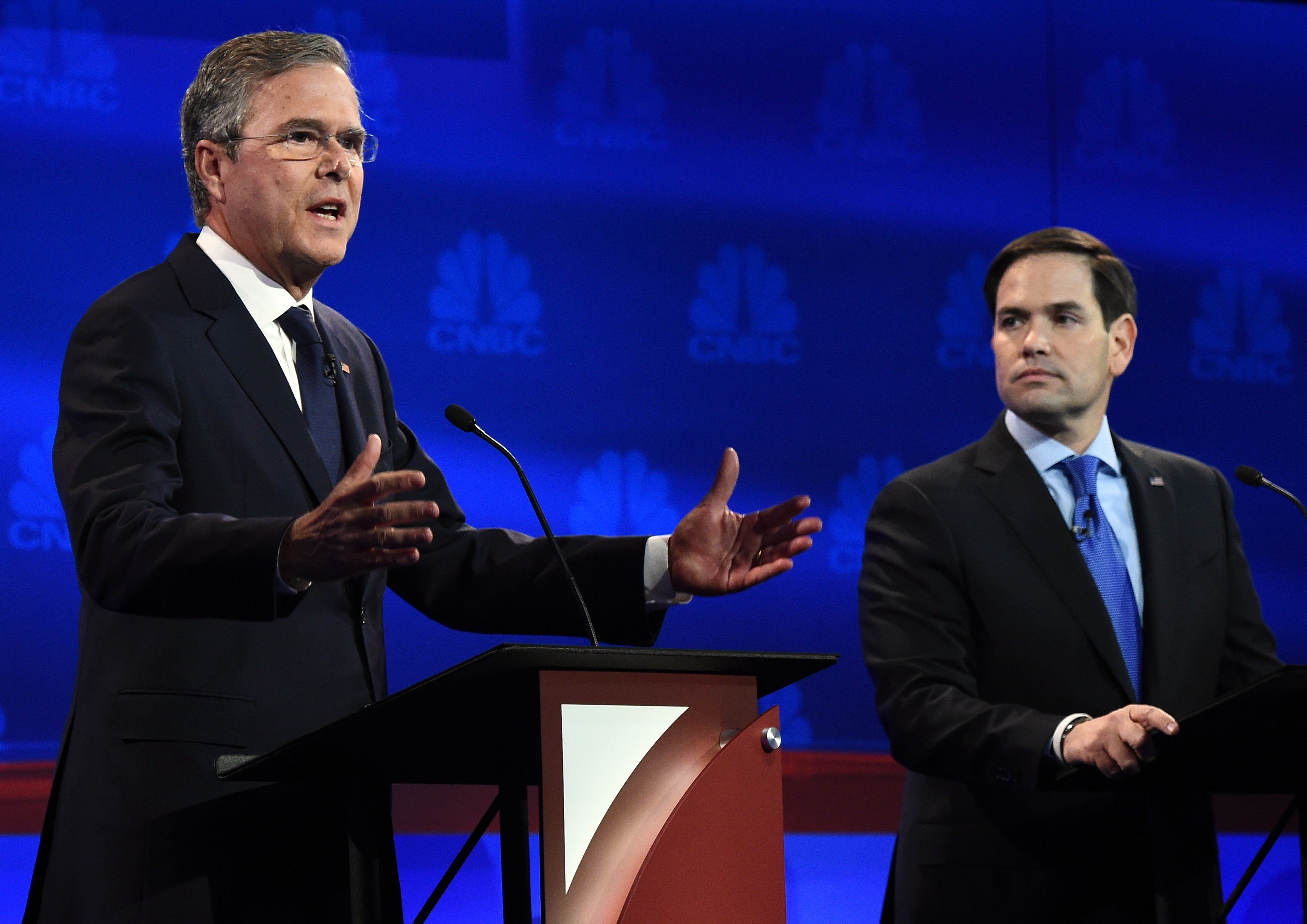 Republican Presidential hopeful Jeb Bush (L) speaks as Marco Rubio looks on during the CNBC Republican Presidential Debate, October 28, 2015 at the Coors Event Center at the University of Colorado in Boulder, Colo.