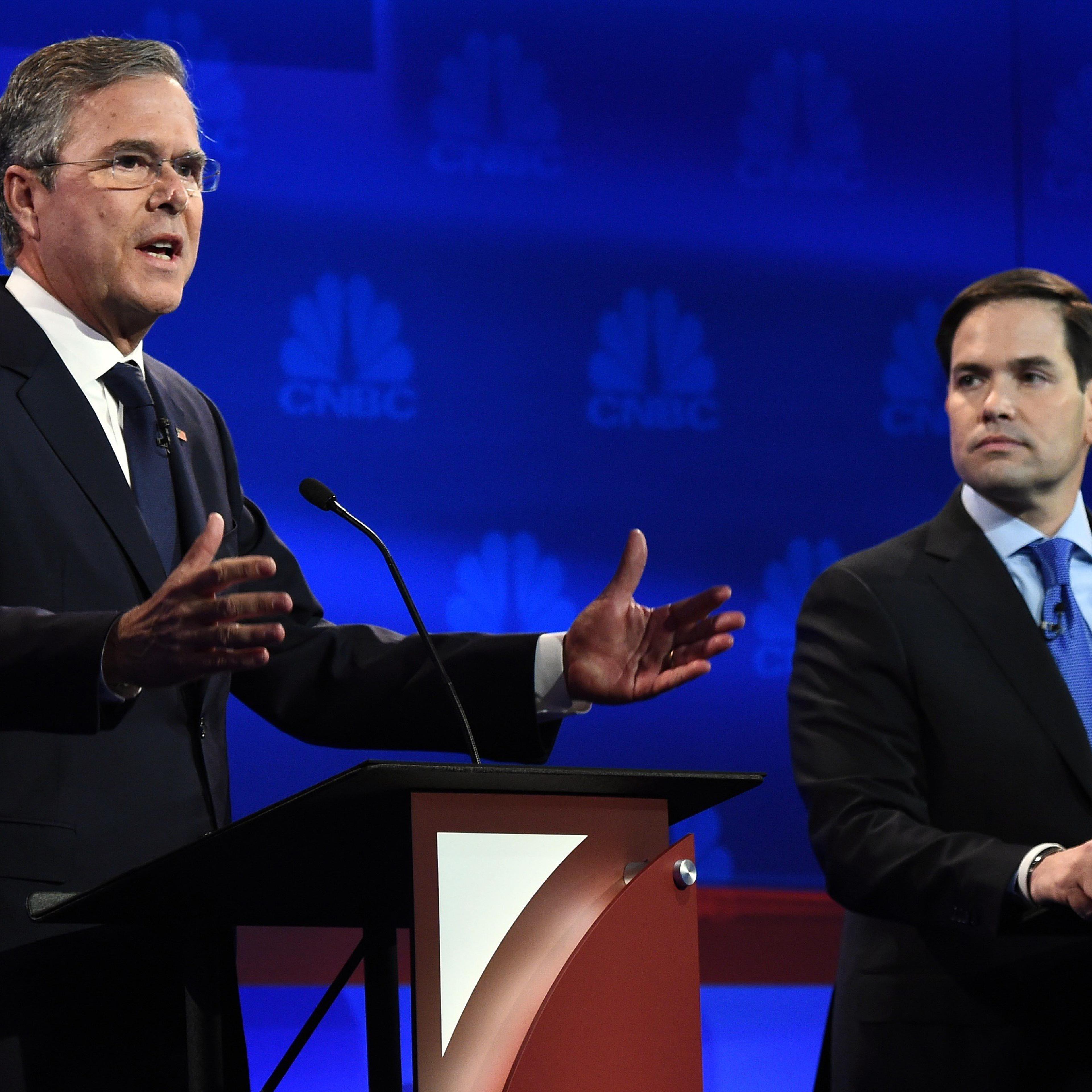 Republican Presidential hopeful Jeb Bush (L) speaks as Marco Rubio looks on during the CNBC Republican Presidential Debate, October 28, 2015 at the Coors Event Center at the University of Colorado in Boulder, Colo.