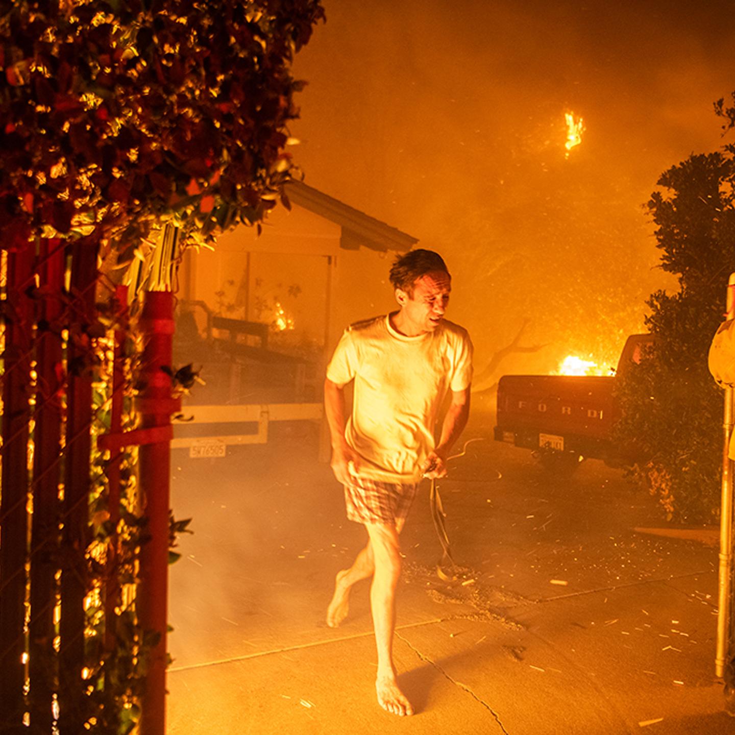 A resident flees his home in Thousand Oaks, Calif., on Nov. 9 with only the clothes on his back. Wildfires erupted in Northern and Southern California in early November, forcing an estimated 160,000 to evacuate.