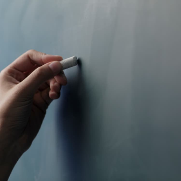 hand-holding-chalk-chalkboard