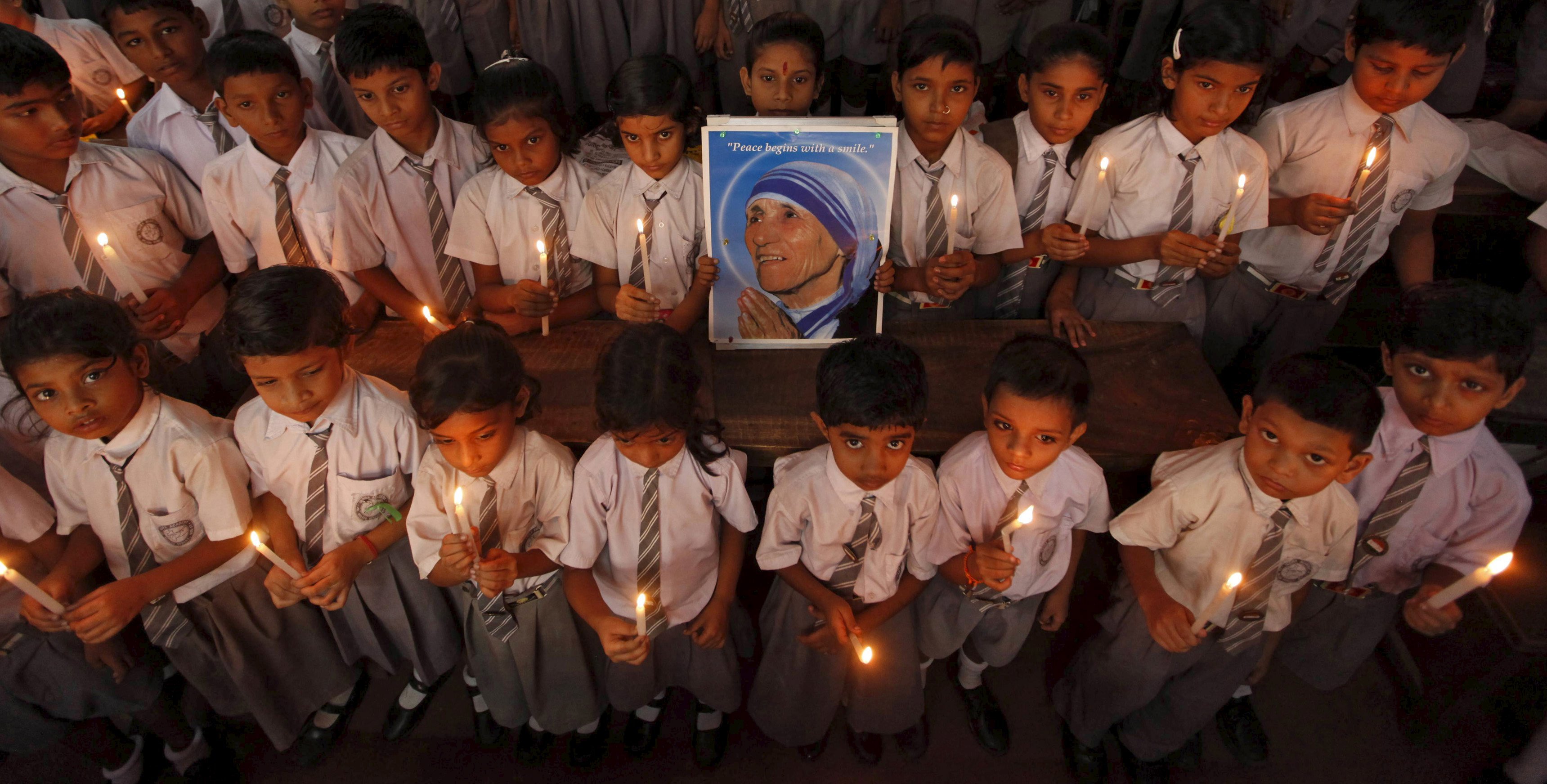 File photo of school children taking part in a candlelight prayer ceremony while holding a portrait of Mother Teresa in Kolkata