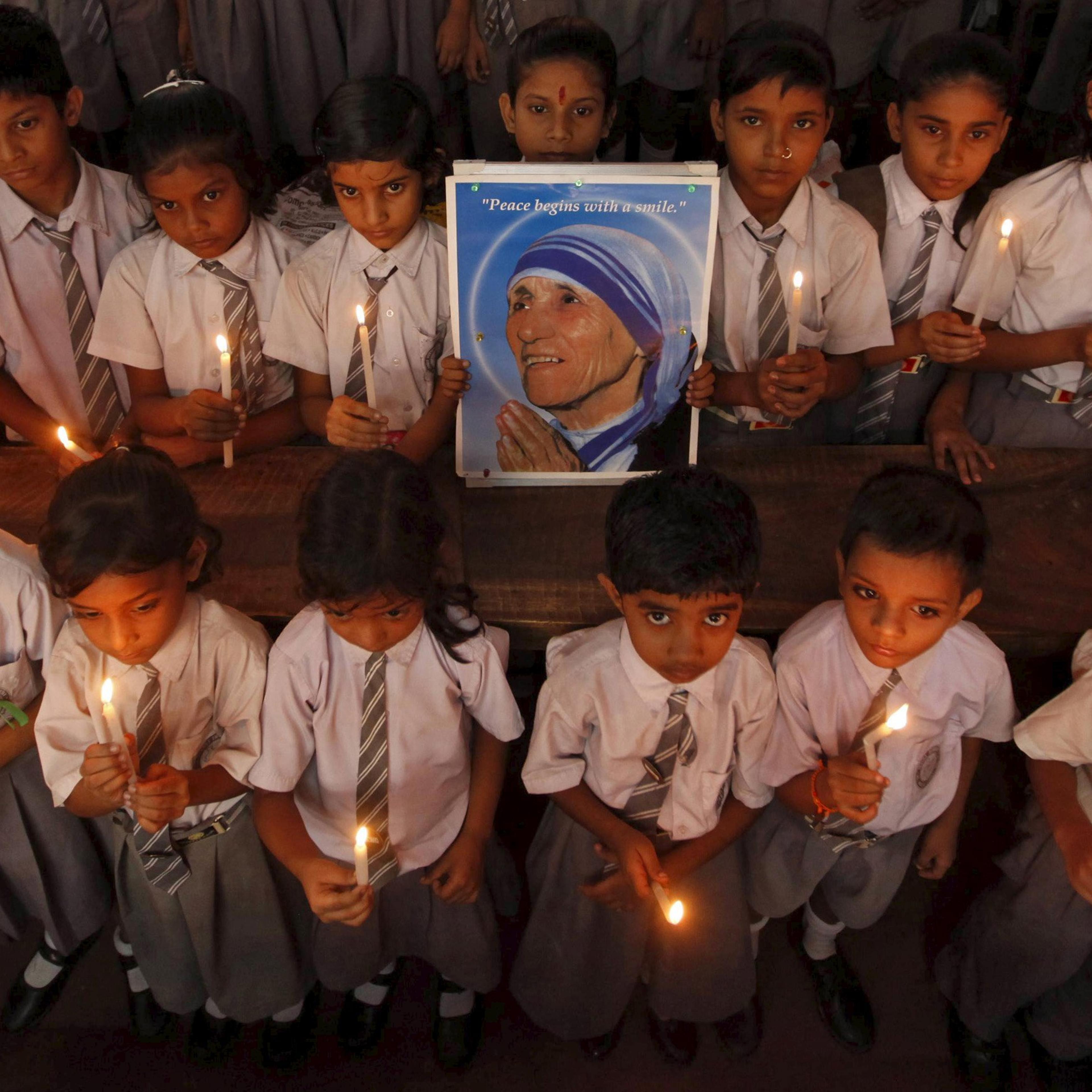 File photo of school children taking part in a candlelight prayer ceremony while holding a portrait of Mother Teresa in Kolkata