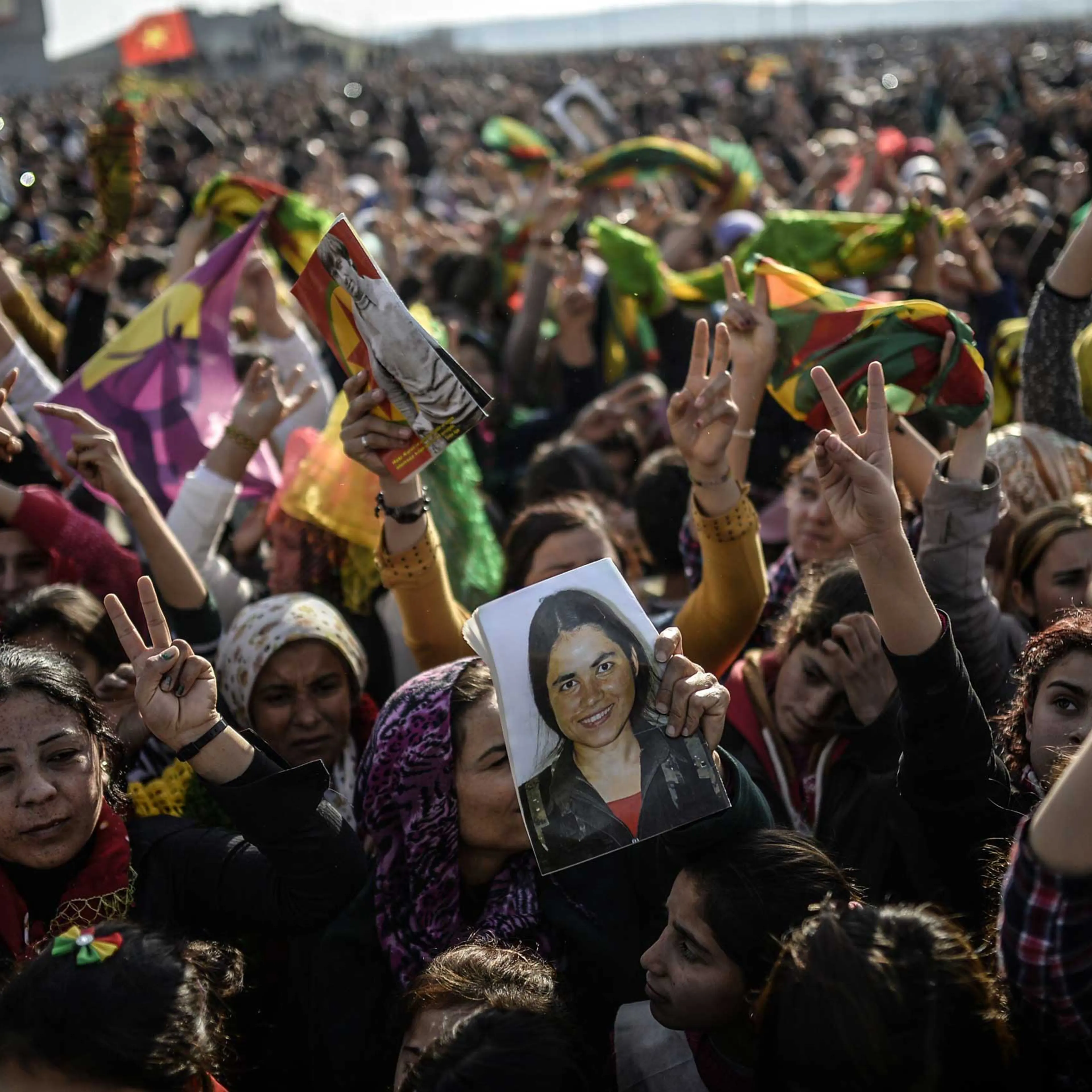 Kurdish people hold a picture of a fighter during a celebration rally near the Turkish-Syrian border at Suruc, Turkey on Jan. 27, 2015. The fighter was killed in battle with Islamic state militants in Kobani.