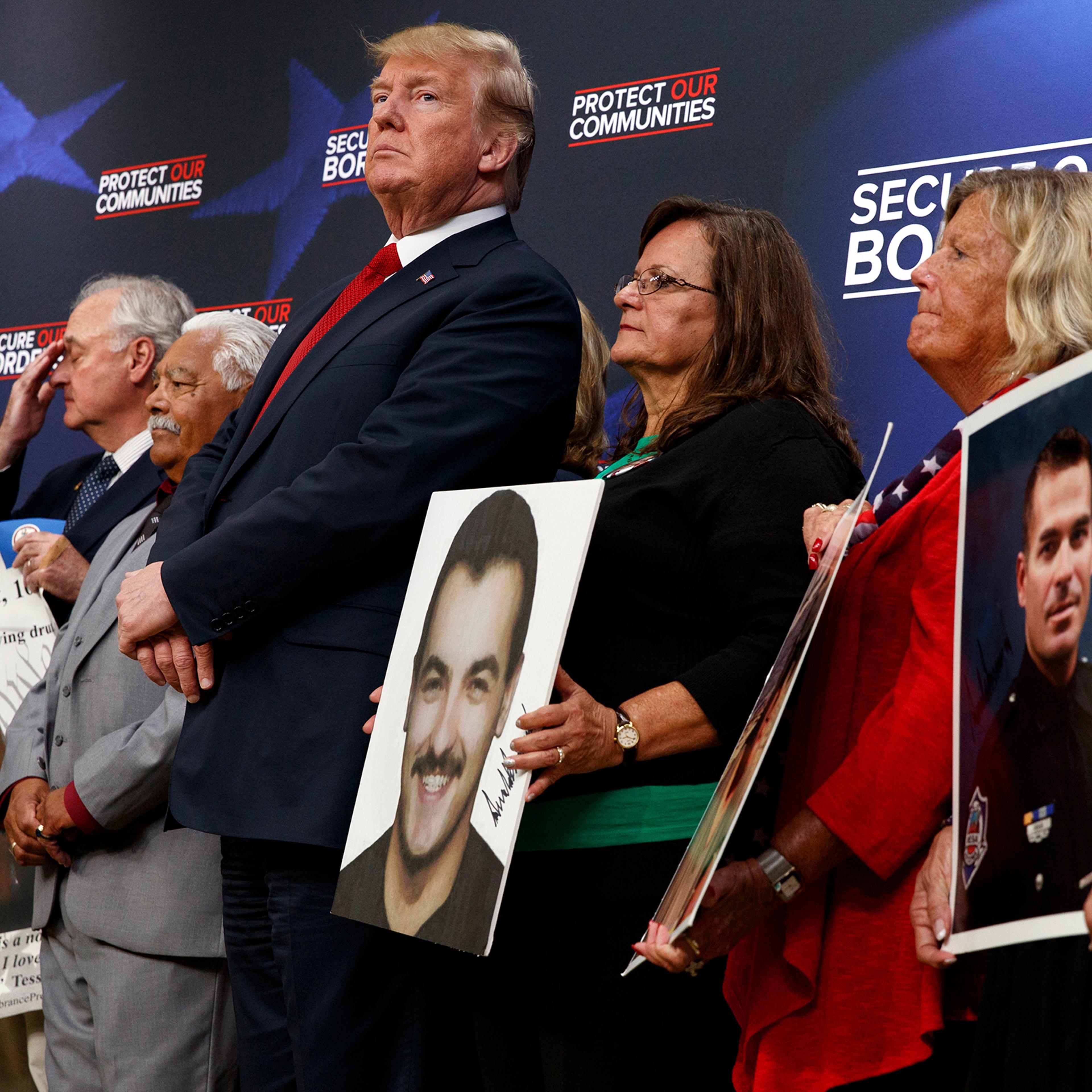 Former President Donald Trump stands alongside "angel families" at the White House complex on June 22, 2018.