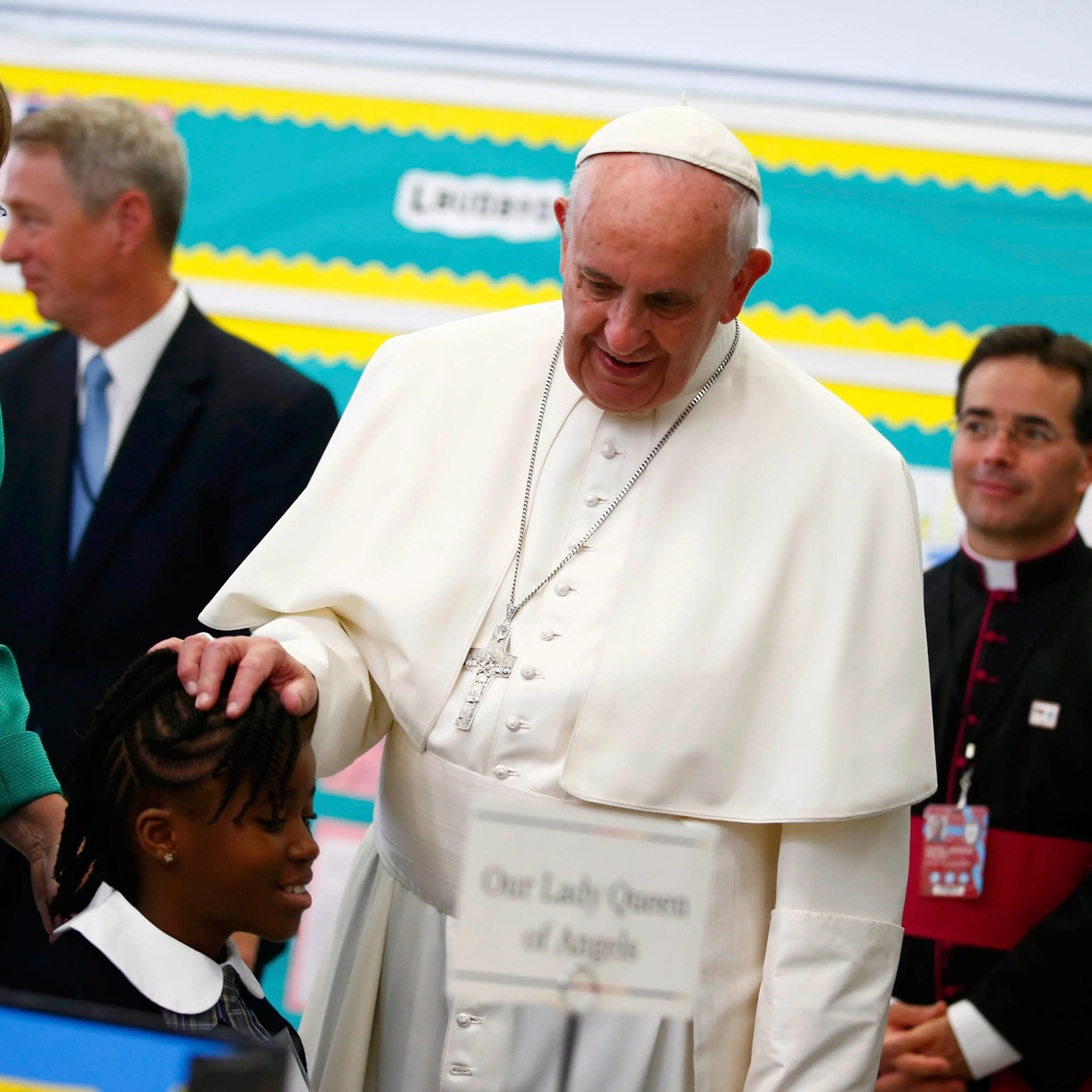 Pope Francis touches a student's head as he visits Our Lady Queen of Angels School in East Harlem in New York