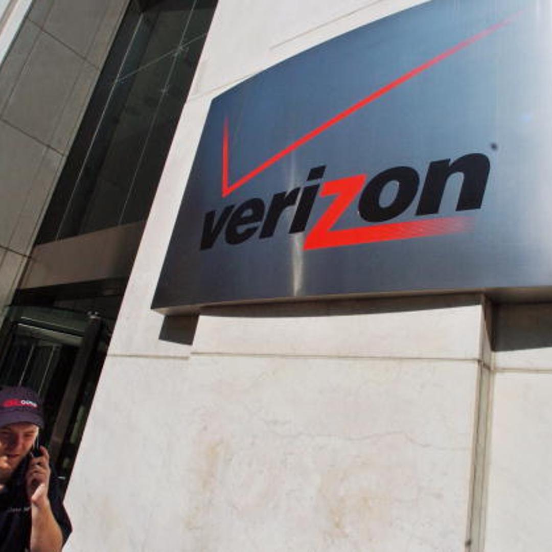A pedestrian walks past the Verizon Communications Inc. headquarters in New York City on July 26, 2005.