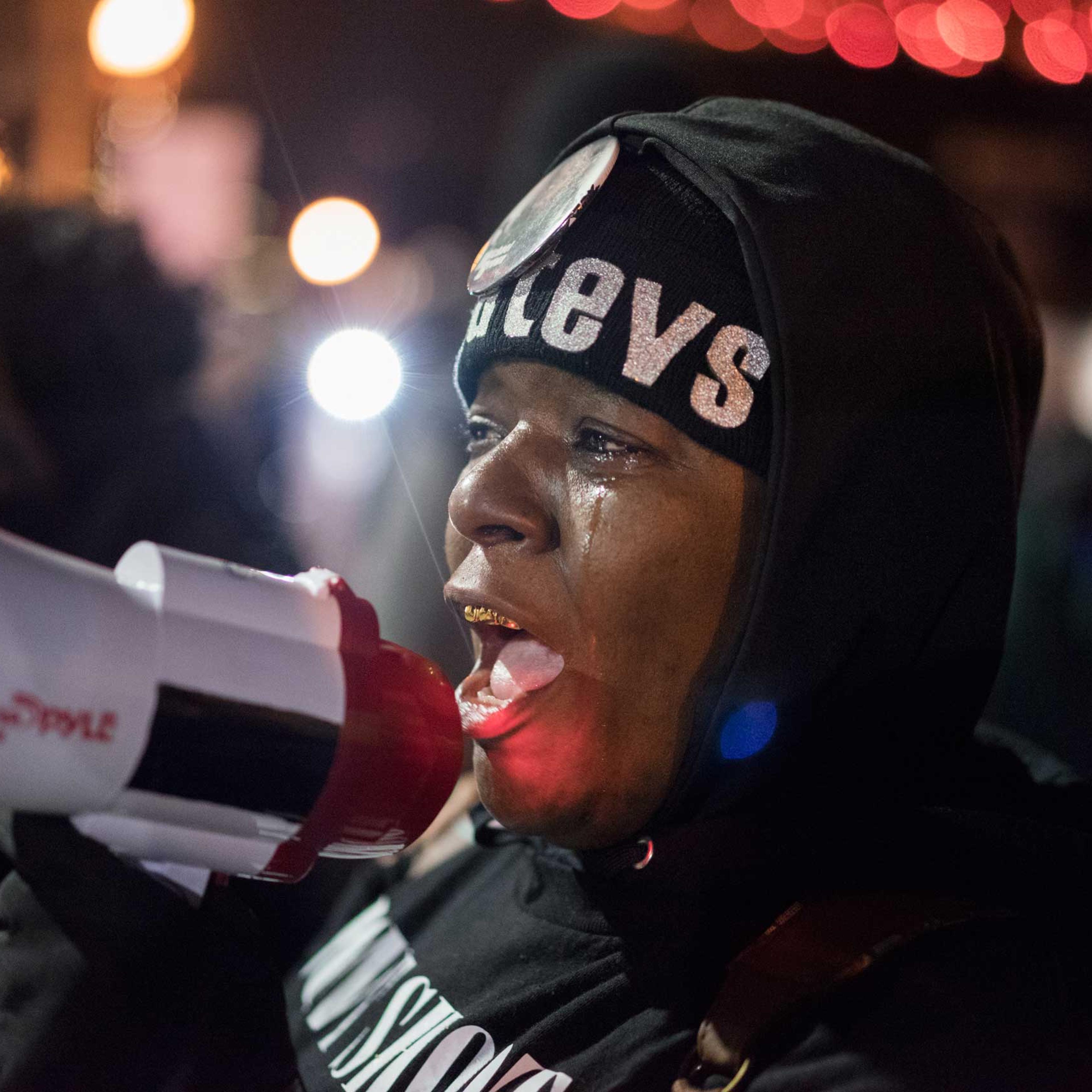 A woman speaks into a megaphone during protests in Ferguson, Mo. on Nov. 24, 2014