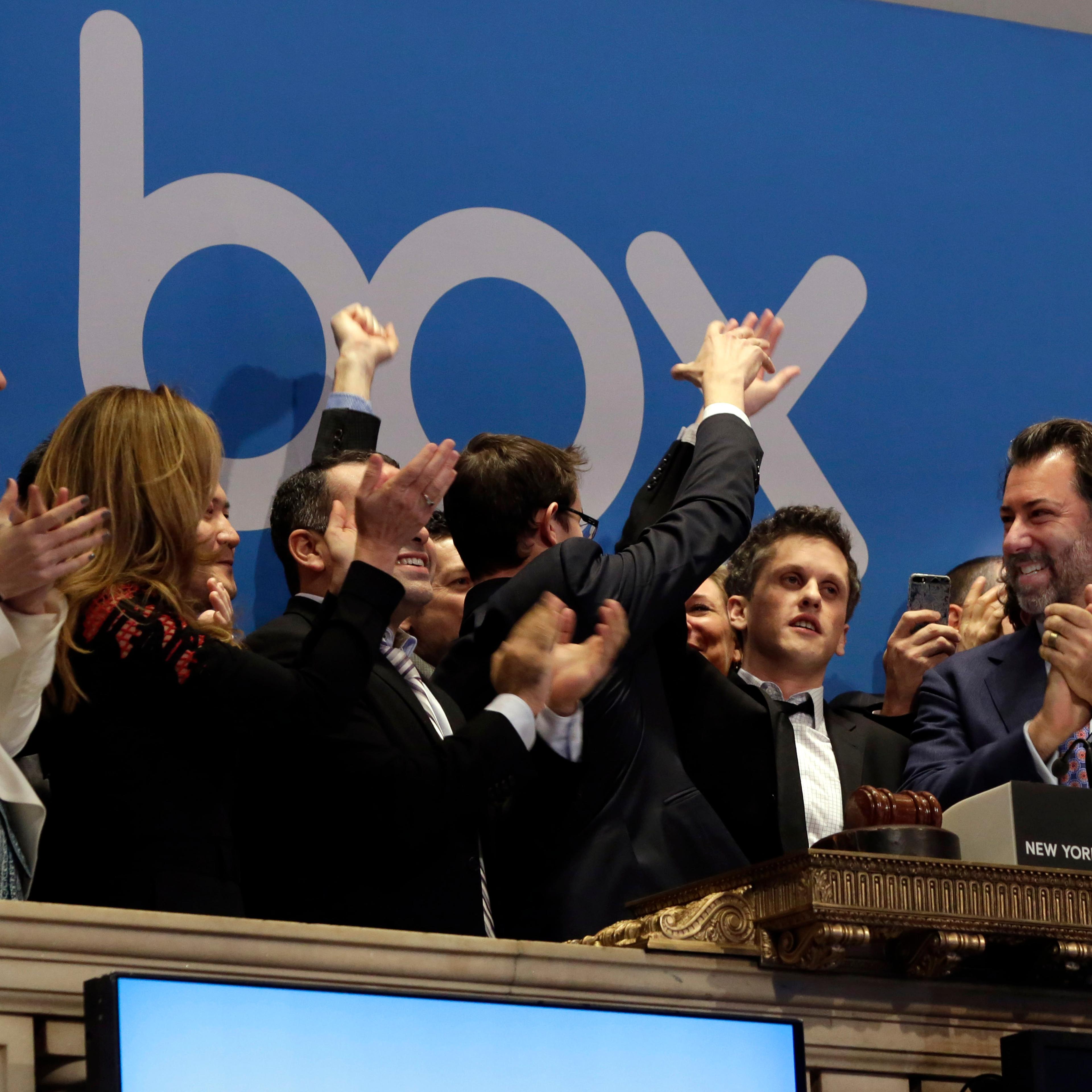 Box, Inc. Chairman, CEO & co-founder Aaron Levie, second from right, gets a high-five during opening bell ceremonies to mark the company's IPO at the New York Stock Exchange on Jan. 23, 2015.
