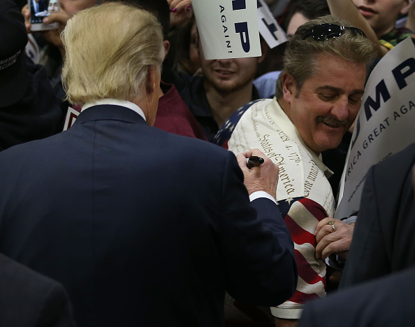 People wait for the doors to open for a Republican presidential candidate Donald Trump campaign rally at Plymouth State University on February 7, 2016 in Holdernes, New Hampshire.