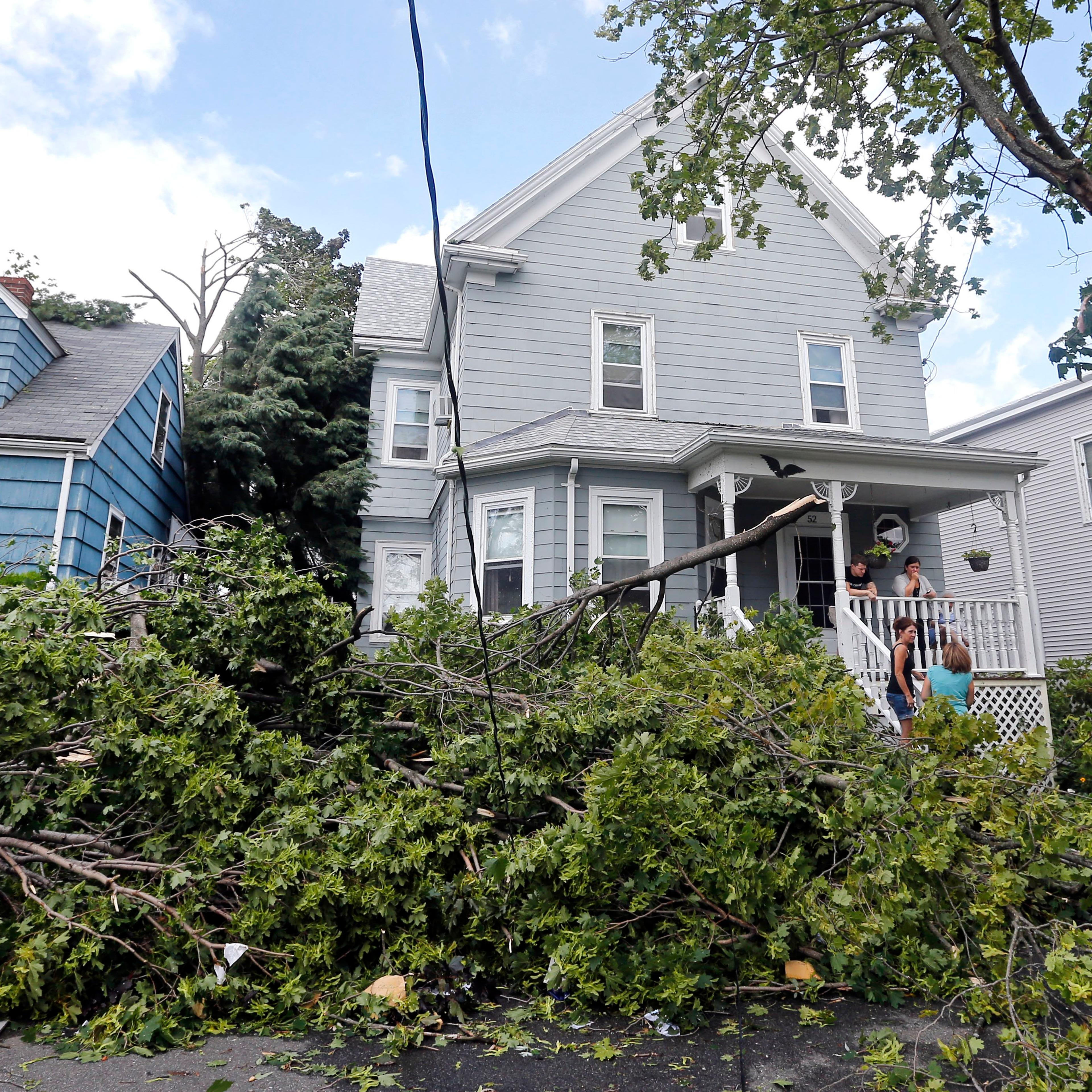 Downed trees and power lines lay in front of homes in Revere, Mass., on July 28, 2014 after a tornado touched down.