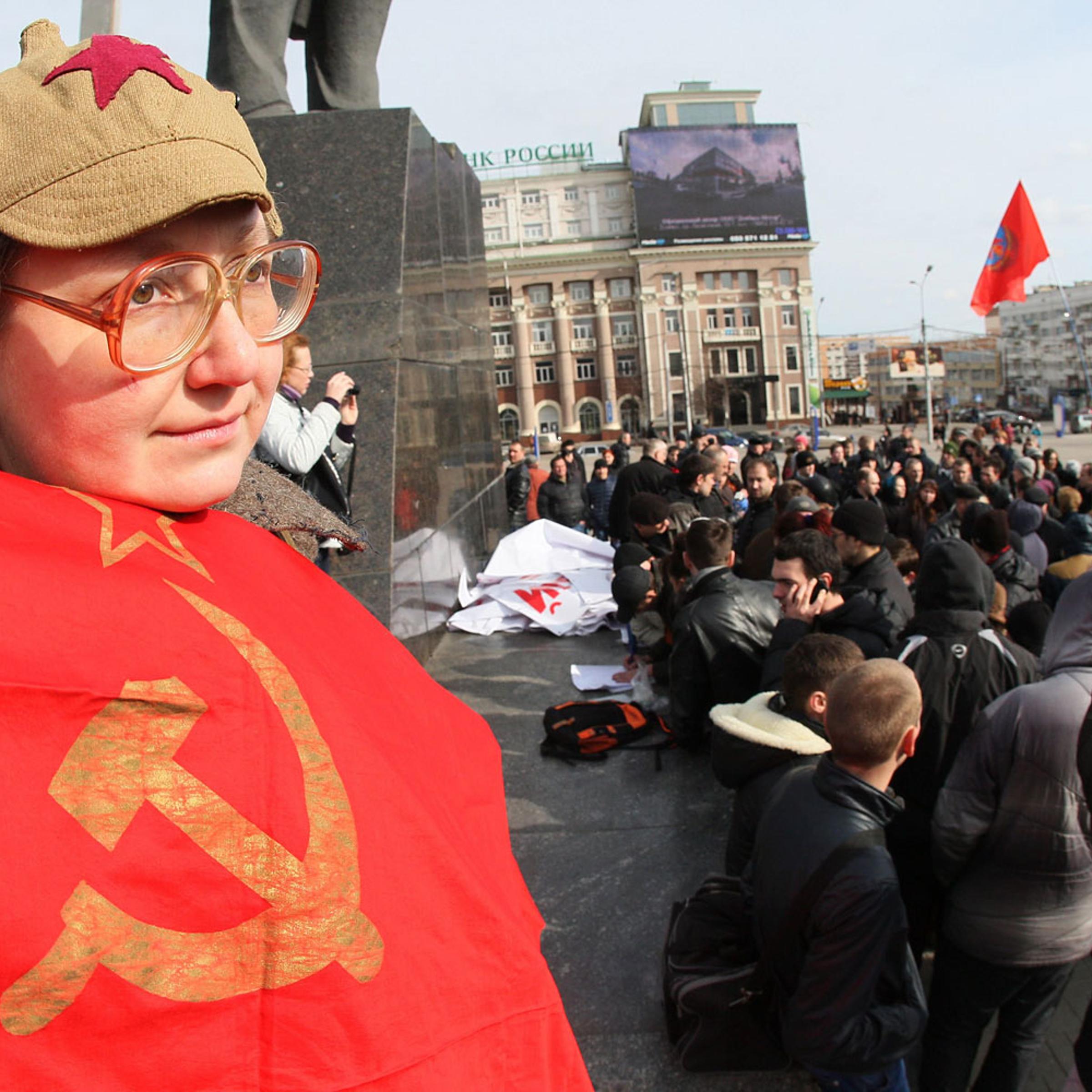 A Ukrainian woman holds a Soviet flag during a rally in the eastern industrial city of Donetsk on Feb. 22, 2014