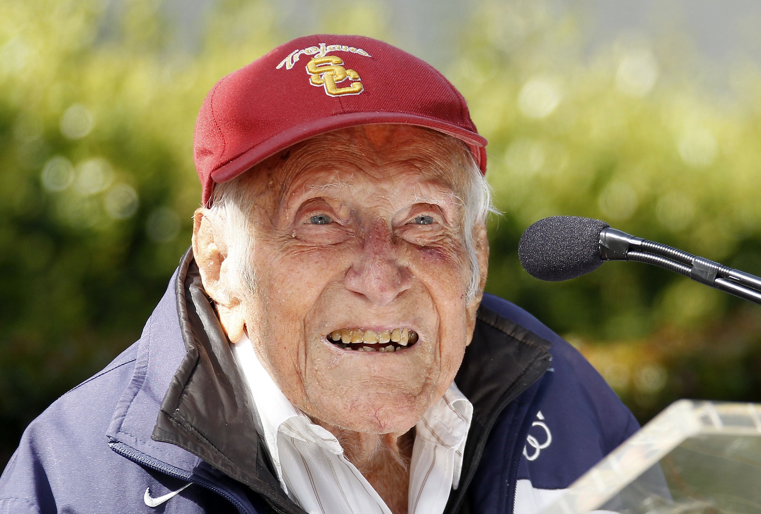 Louis Zamperini gestures during a news conference, in Pasadena, Calif. Zamperini, a U.S. Olympic distance runner and World War II veteran who survived 47 days on a raft in the Pacific after his bomber crashed, then endured two years in Japanese prison ca
