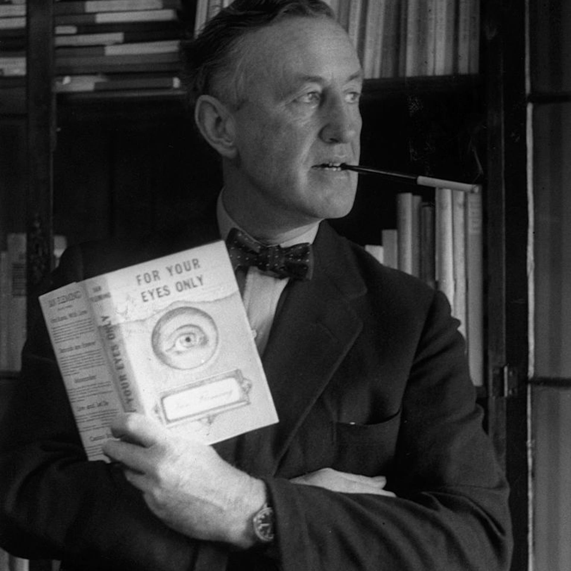 English author Ian Fleming (1908 - 1964) in his study with a copy of 'For Your Eyes Only', one of the series of James Bond novels that he wrote.