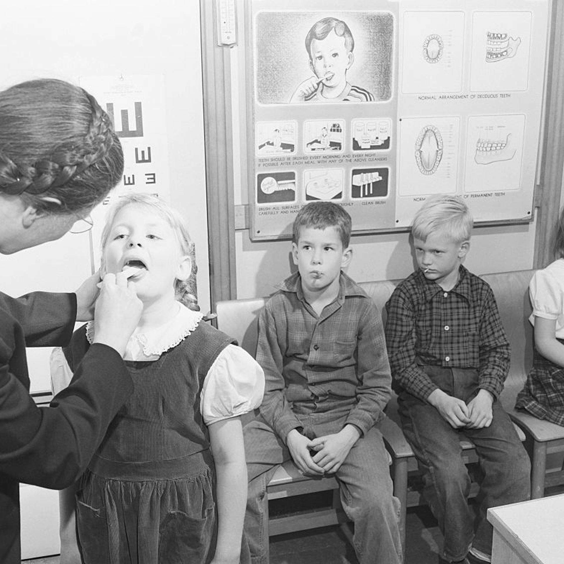 Nurse Checking Nursery Schooler's Teeth