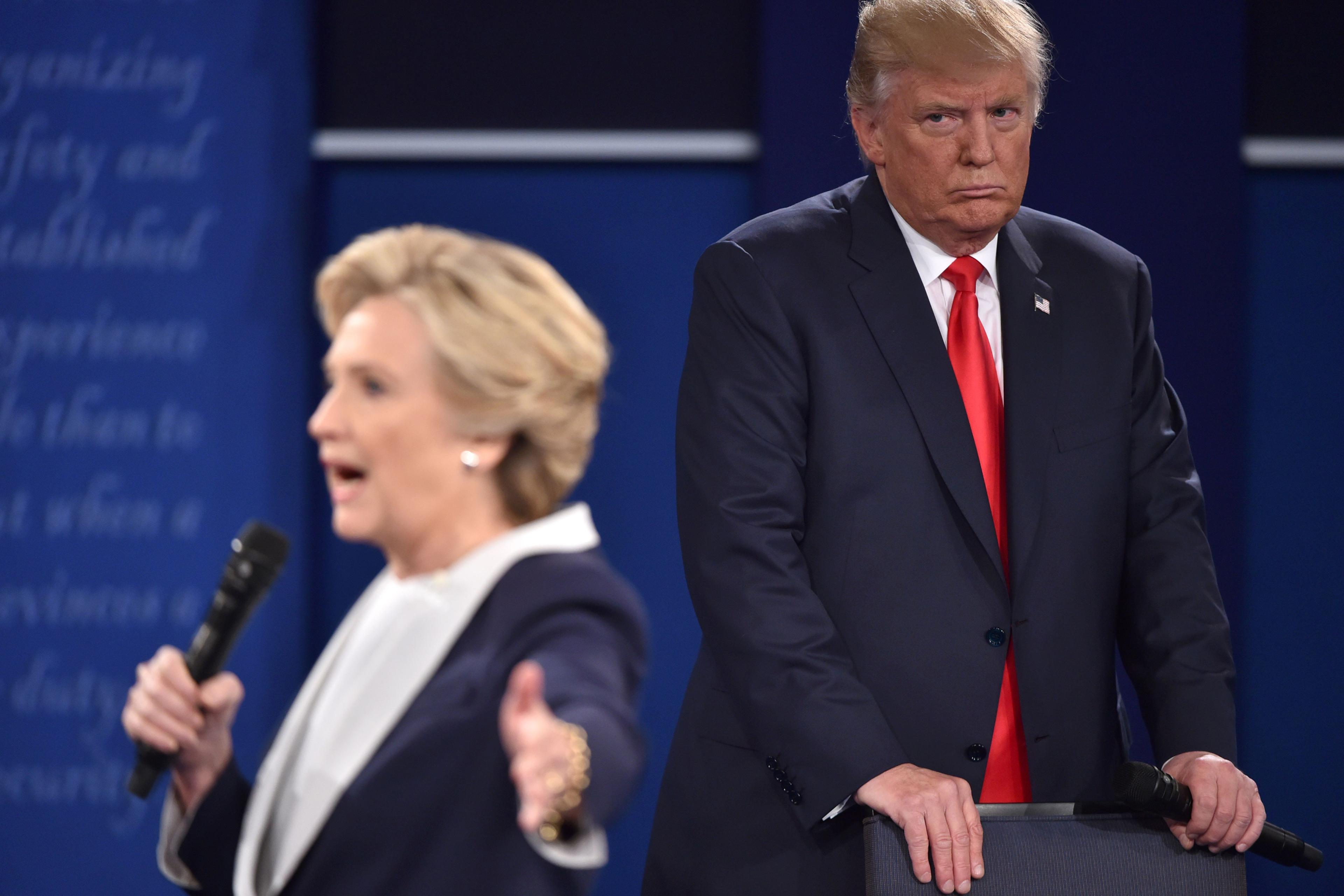 Donald Trump listens to Hillary Clinton during the second presidential debate at Washington University in St. Louis, Missouri, on Oct. 9, 2016.