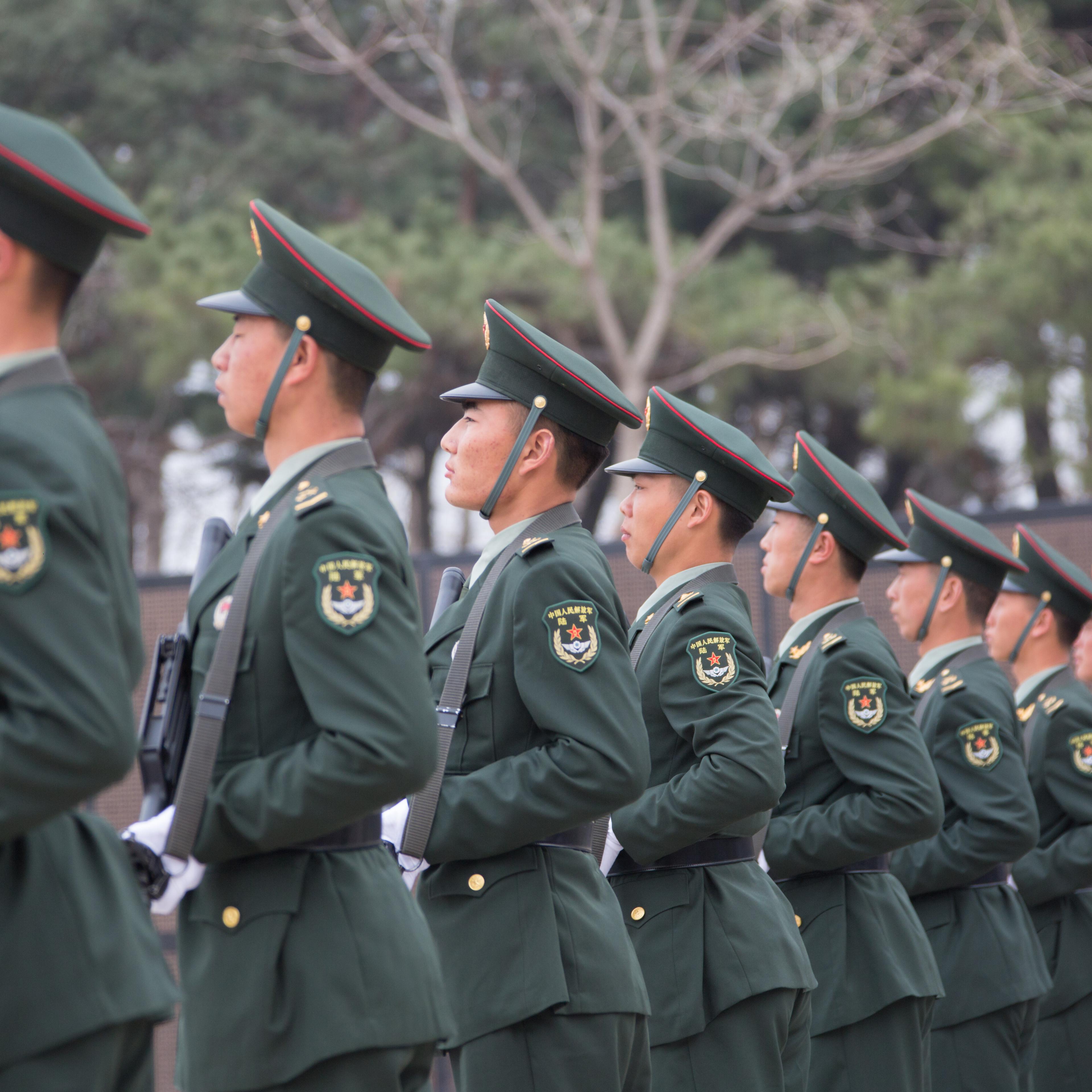 People's Liberation Army officers stand guard as a burial ceremony for the remains of 36 Chinese soldiers who died in the Korean War is held early morning at Korean War Martyrs' Cemetery on April 1, 2016 in Shenyang, Liaoning Province of China.
