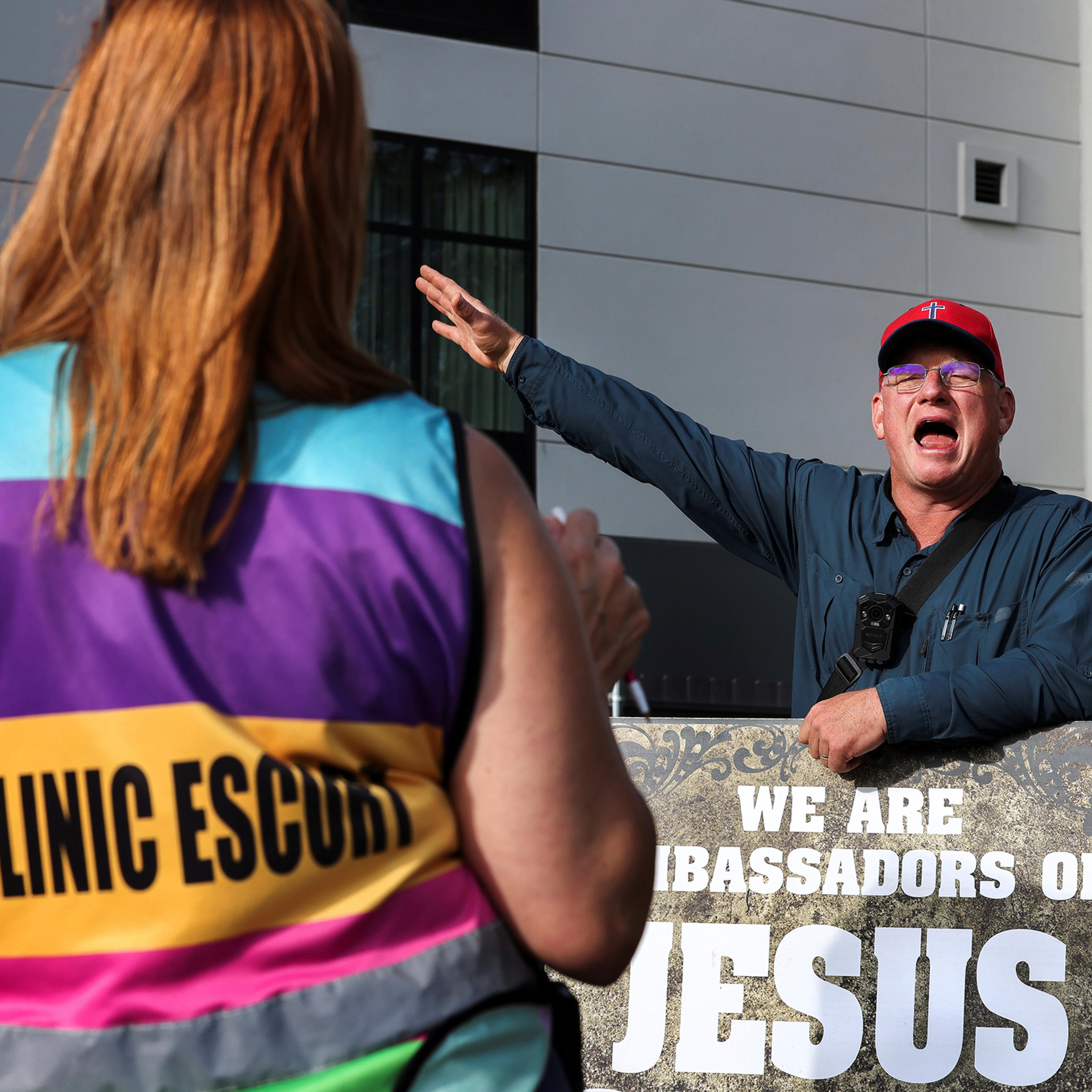 An anti-abortion protestor argues with volunteer clinic escort Kim Gibson outside the Jackson Women's Health Organization in Mississippi, May 2021