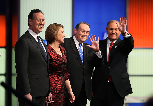 Republican presidential candidates (L-R) Rick Santorum, Carly Fiorina, Mike Huckabee and Jim Gilmore pose for photographers prior to the Fox News - Google GOP Debate January 28, 2016 at the Iowa Events Center in Des Moines, Iowa.