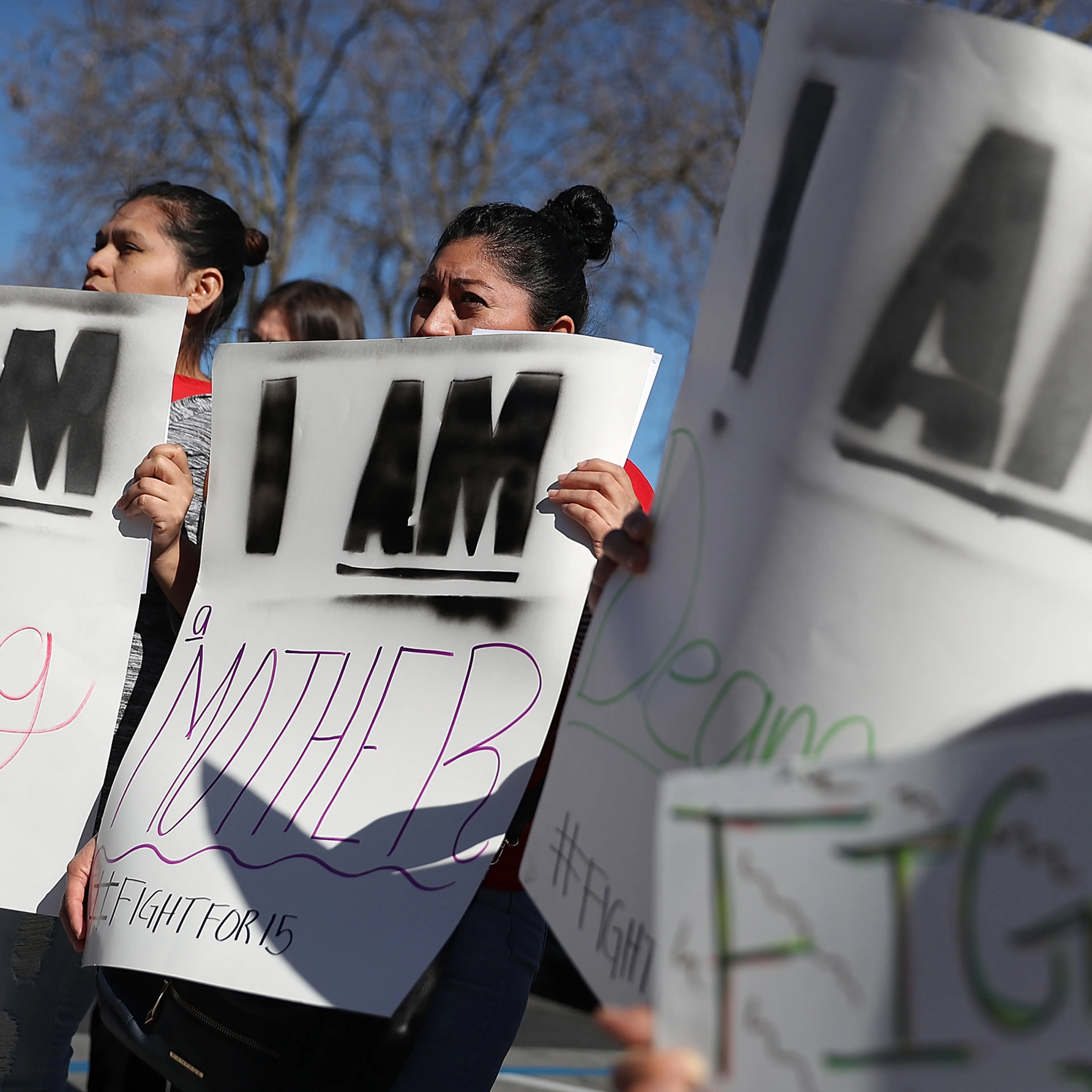 Fast food workers and union members carry signs as they stage a protest outside of a McDonald's restaurant in Oakland, Calif., on Feb. 12, 2018, the 50th anniversary of the historic Memphis Sanitation Strike that was led by Dr. Martin Luther King Jr.