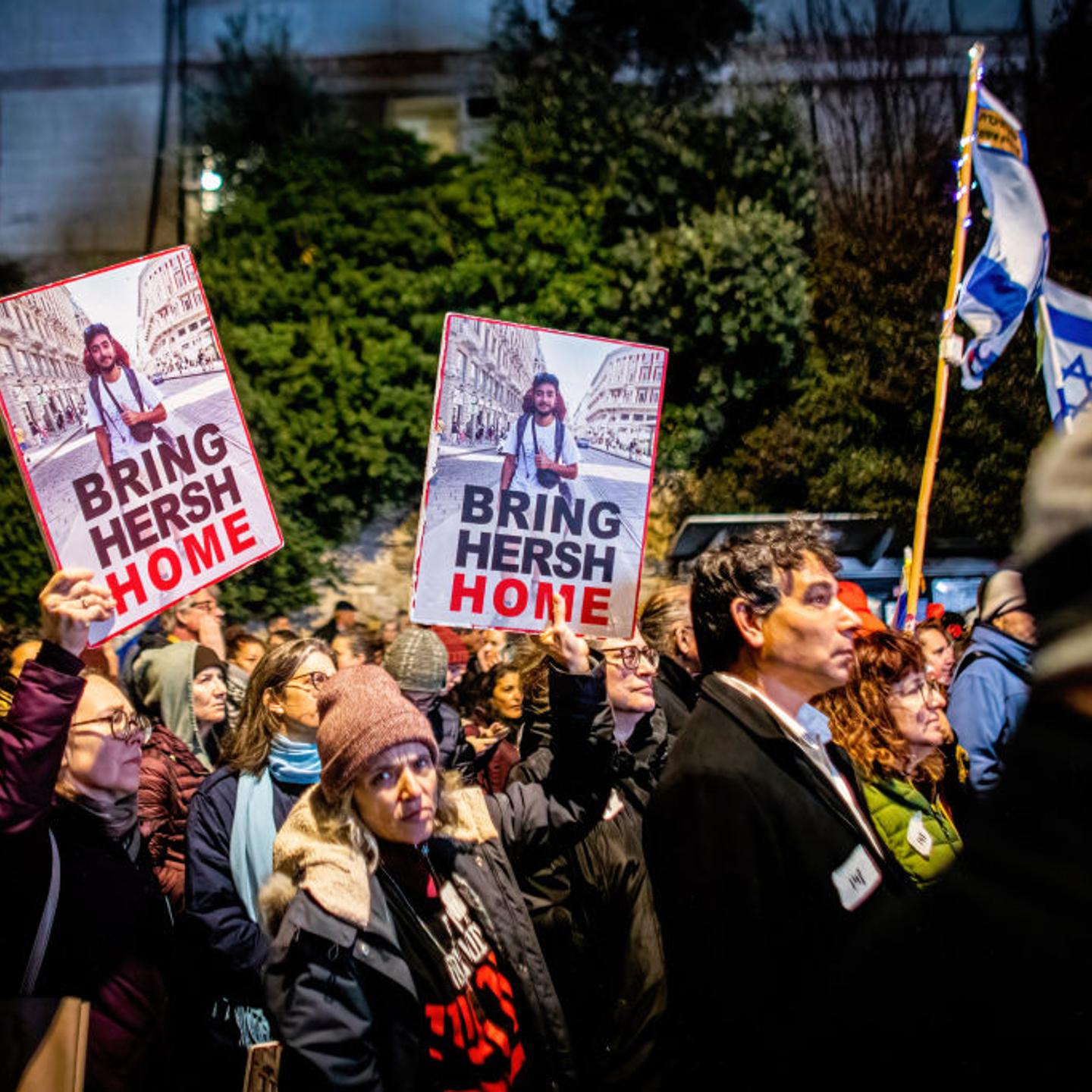 Protesters hold posters of 23-year-old American-Israeli