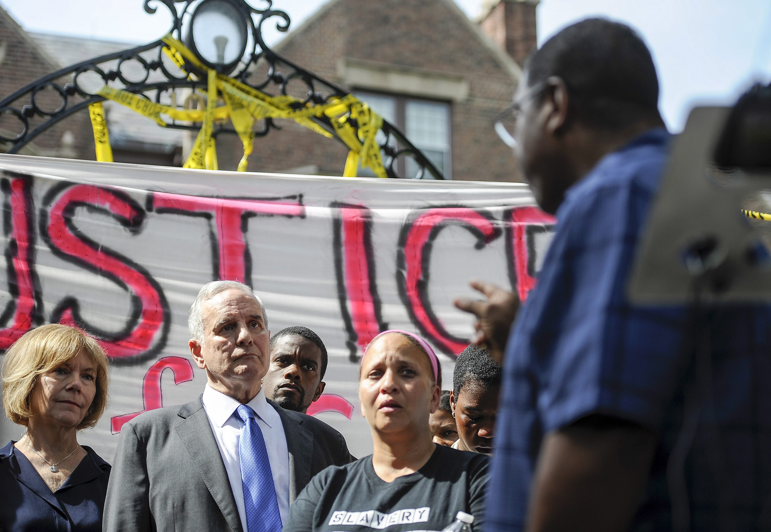 Brian Herron, Pastor of Zion Baptist Church in Minneapolis, turns from the podium to address Minnesota Governor Mark Dayton as he speaks about the police shooting of Philando Castile, during a news conference in front of the governors residence in St. Pa