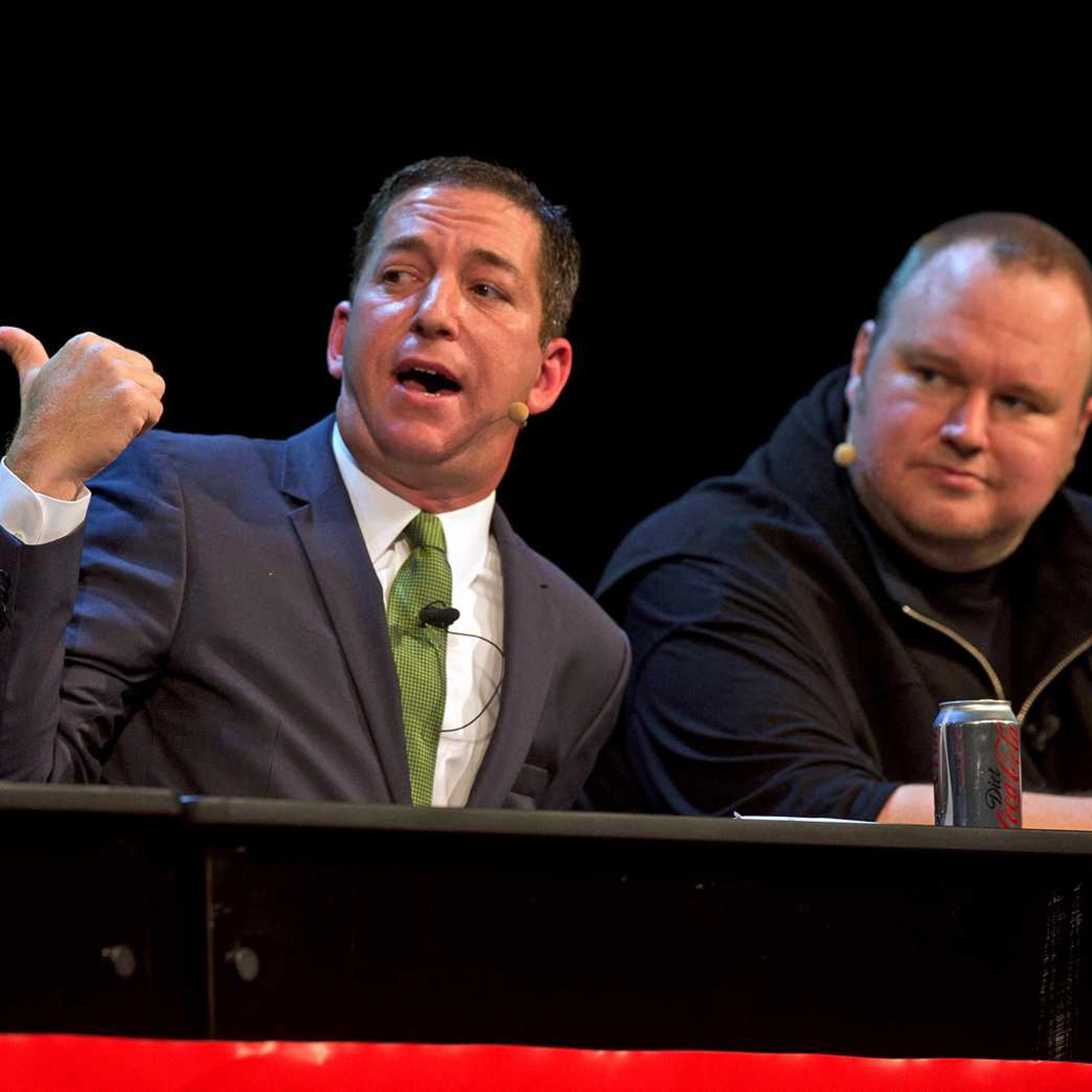Journalist and author Glenn Greenwald, left, and Kim Dotcom attend a political forum at Town Hall in Auckland, New Zealand Monday, Sept. 15, 2014.